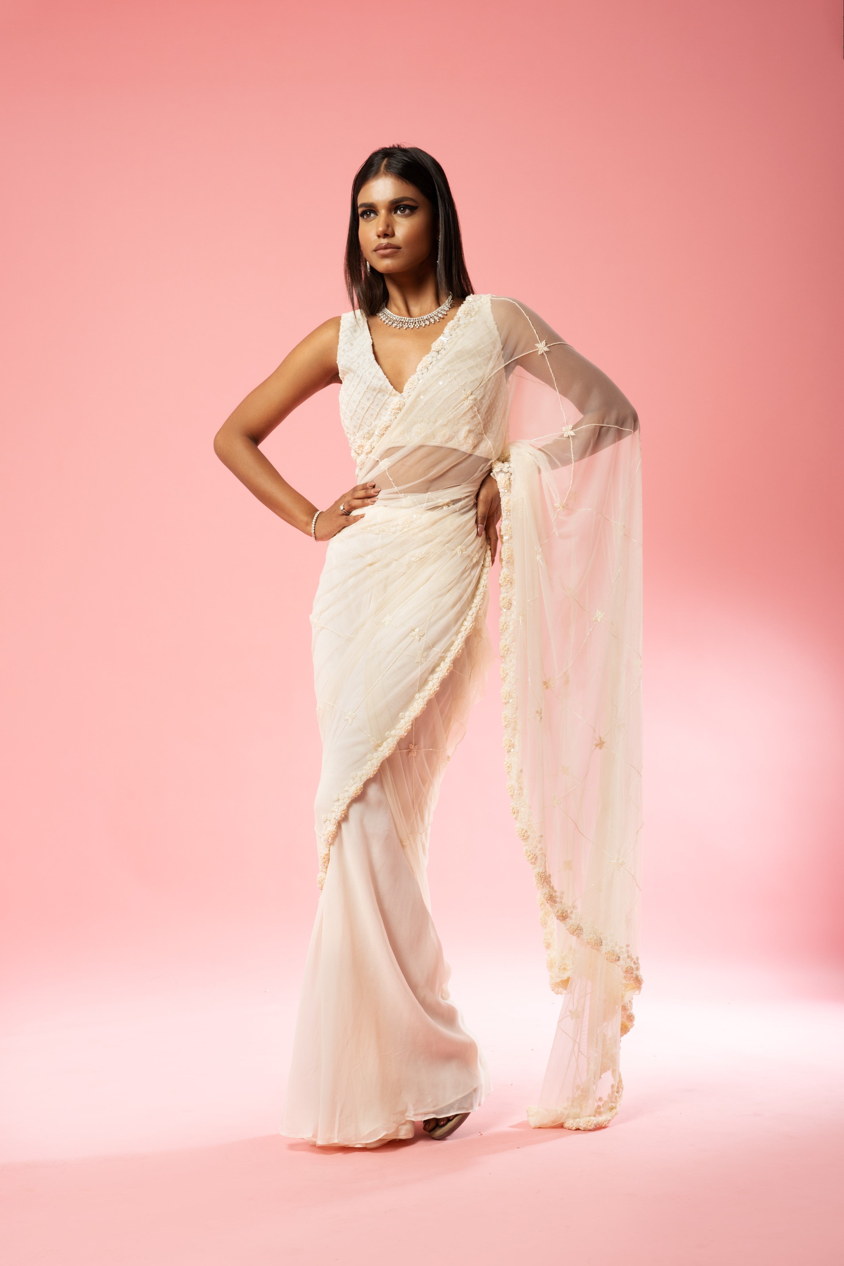 Ivory pre-stitched saree with hand embroidery on blouse and pallu.