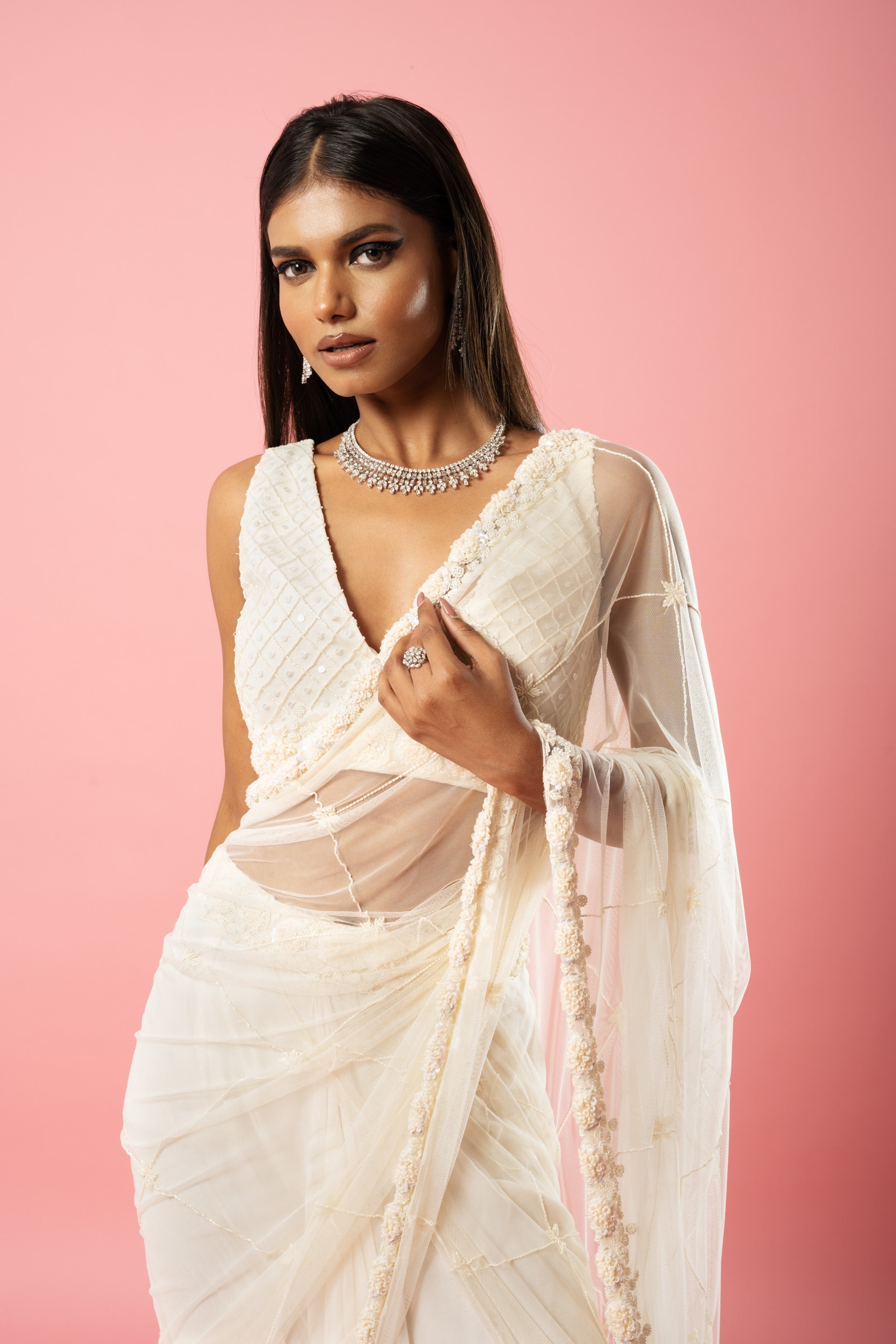 Ivory pre-stitched saree with hand embroidery on blouse and pallu.