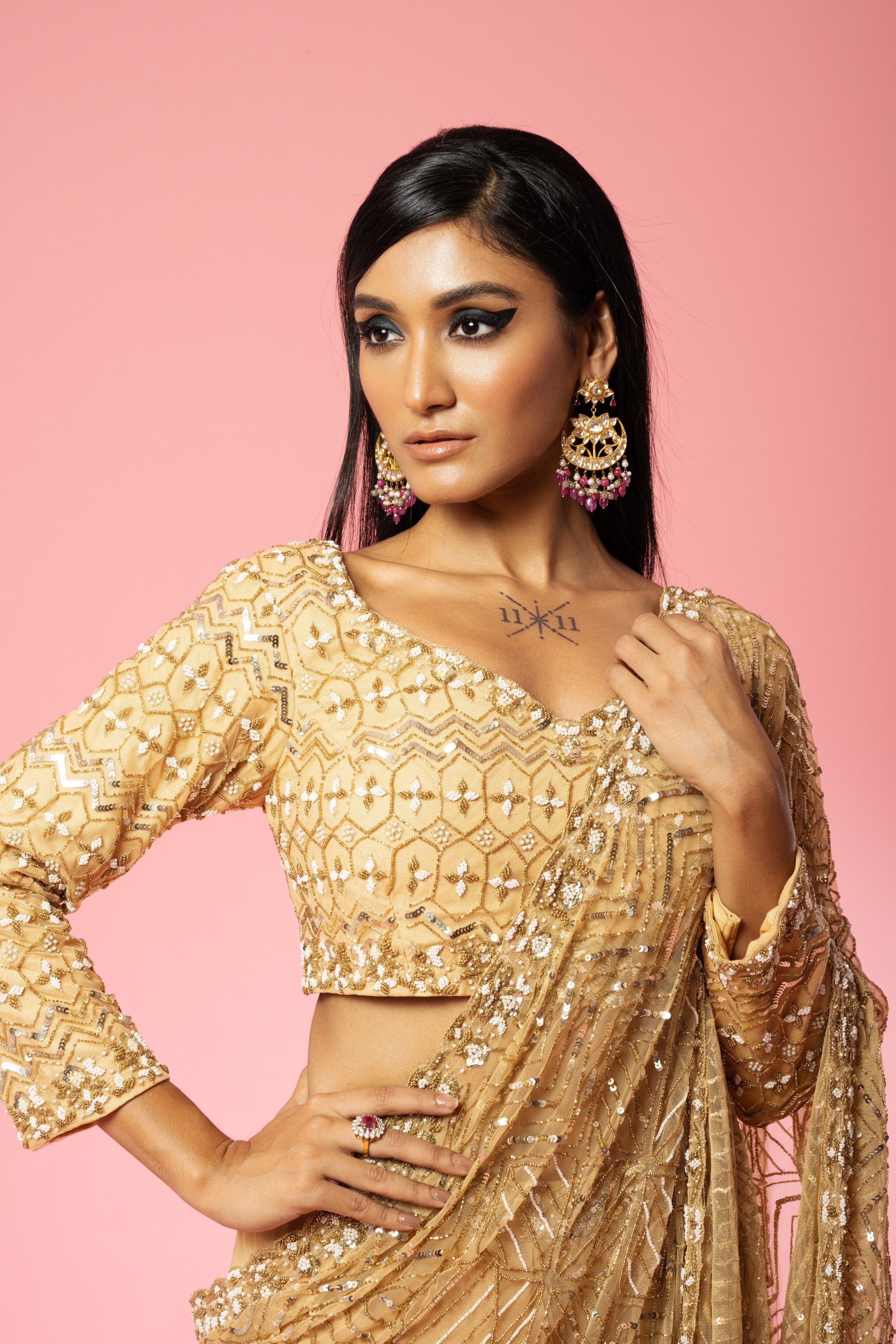 Golden pre-stitched saree with intricate hand embroidery.