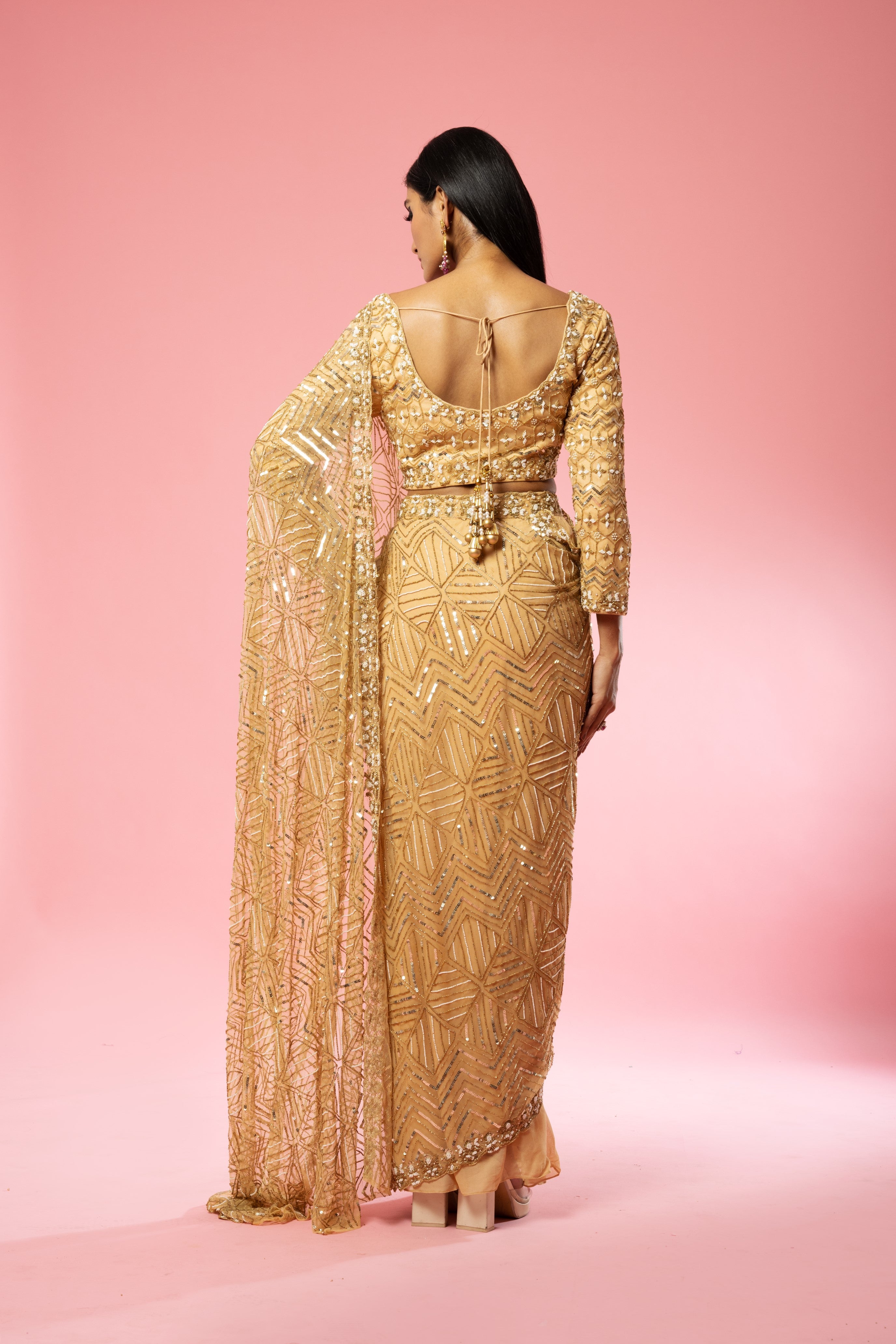 Golden pre-stitched saree with intricate hand embroidery.