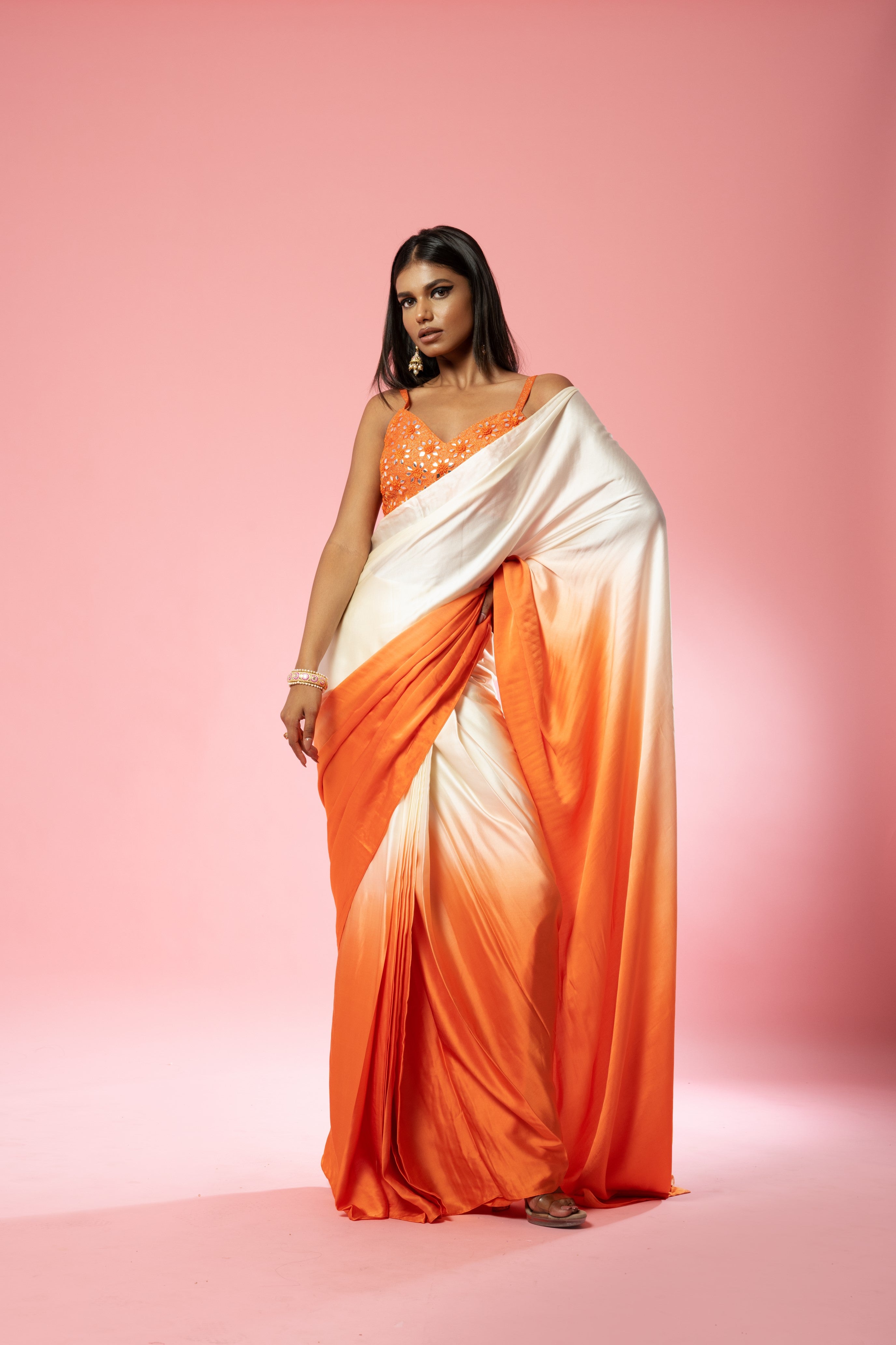 Ivory and orange ombre saree with hand-embroidered blouse.