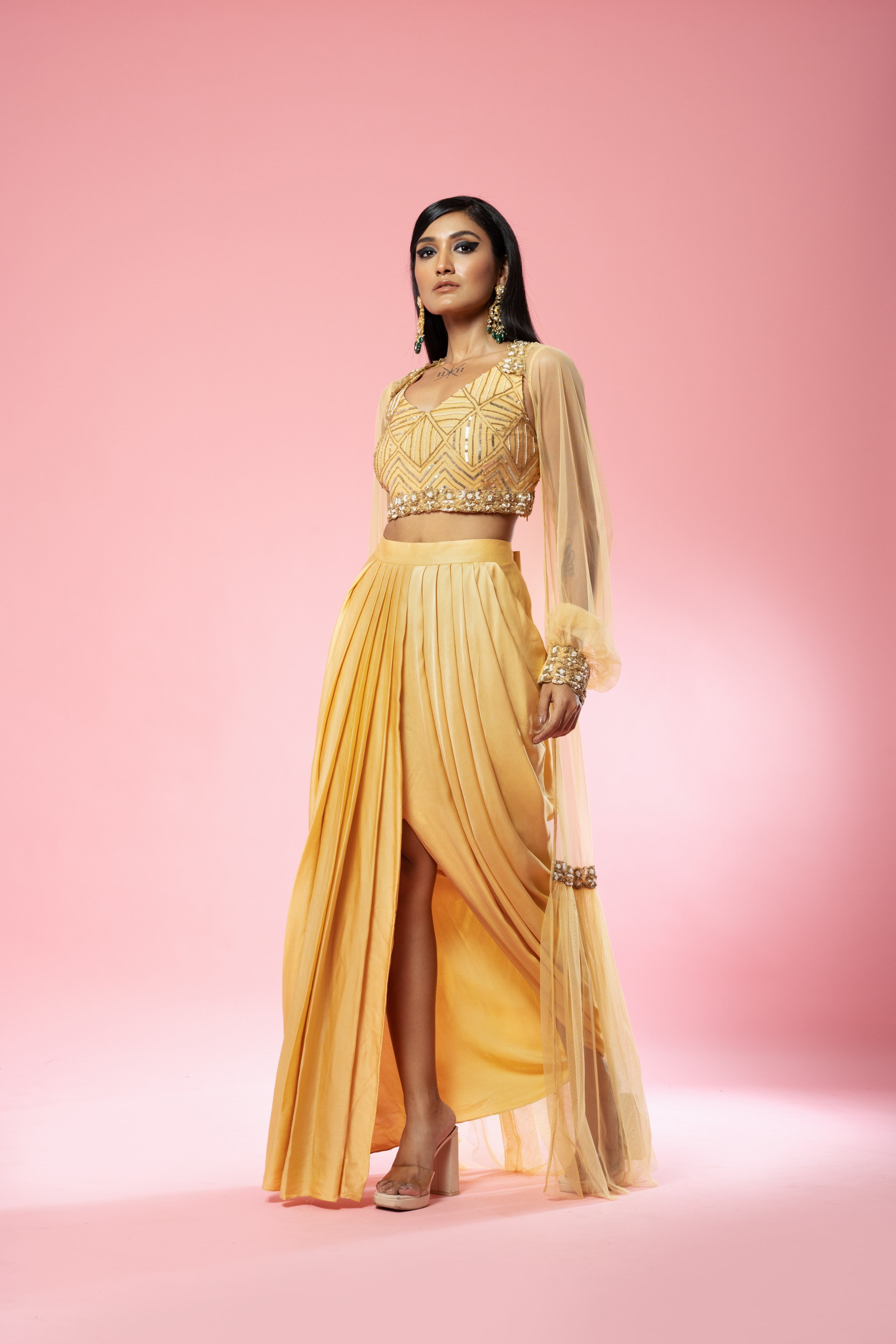 Golden dhoti set with hand-embroidered blouse and cape.