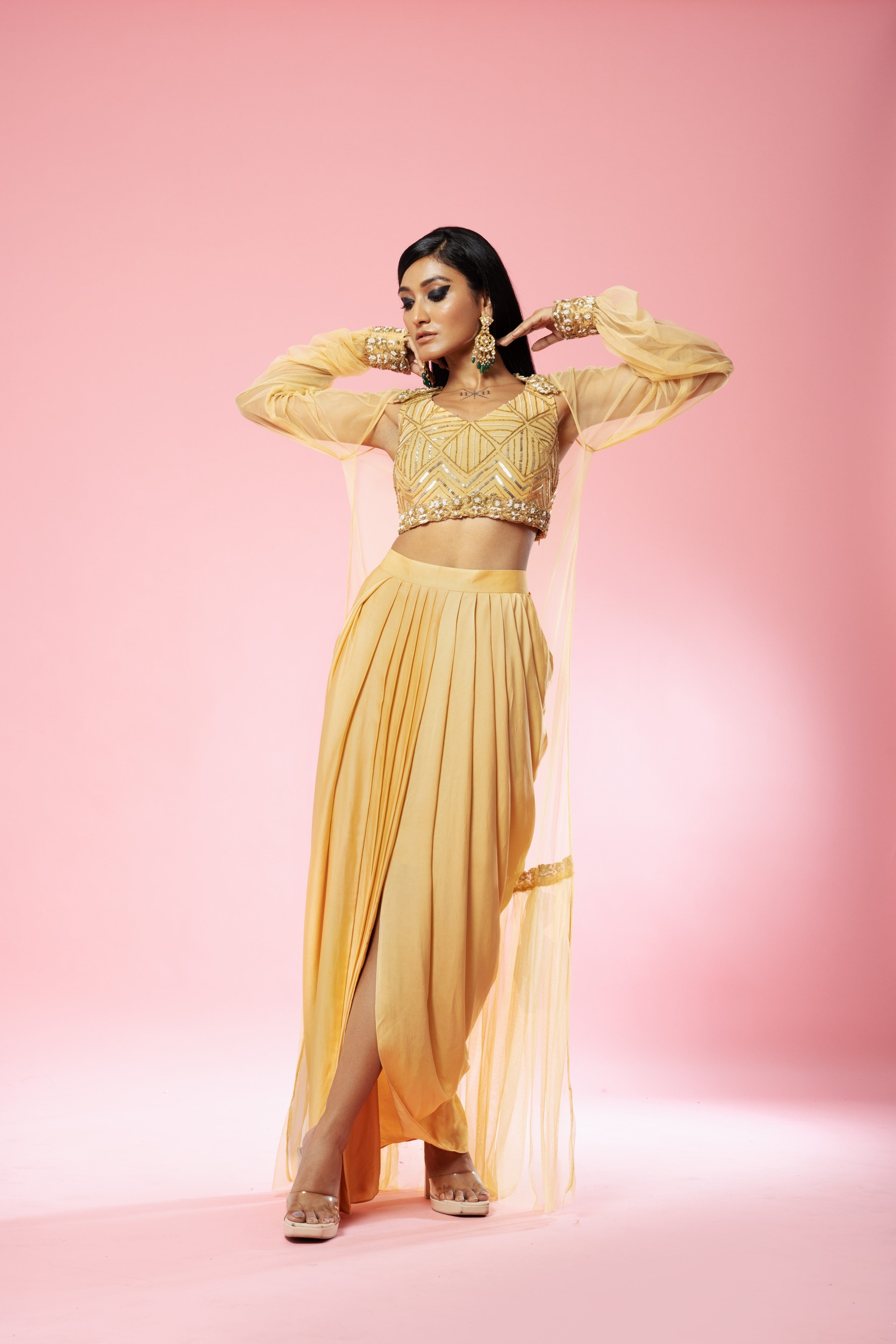 Golden dhoti set with hand-embroidered blouse and cape.