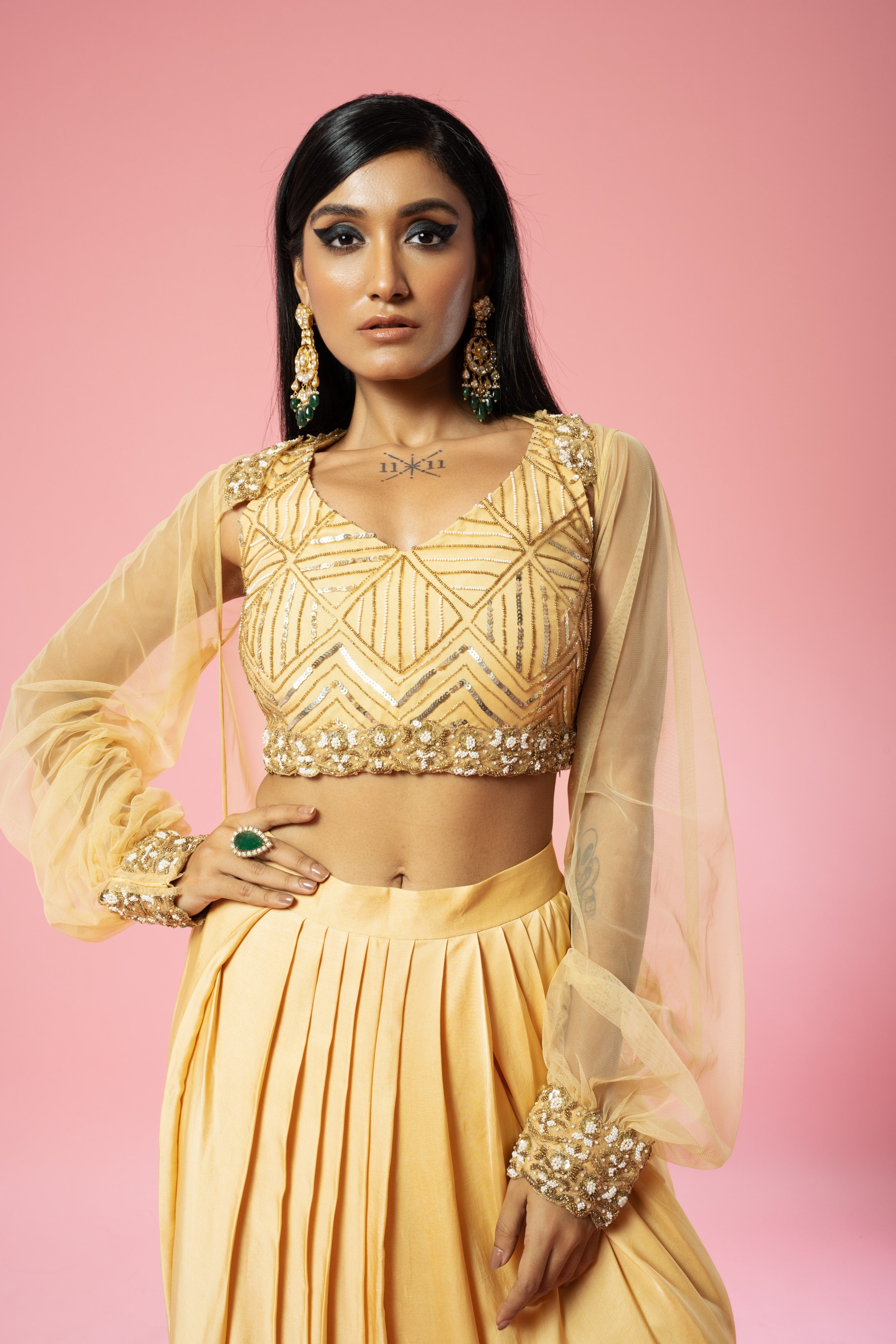 Golden dhoti set with hand-embroidered blouse and cape.