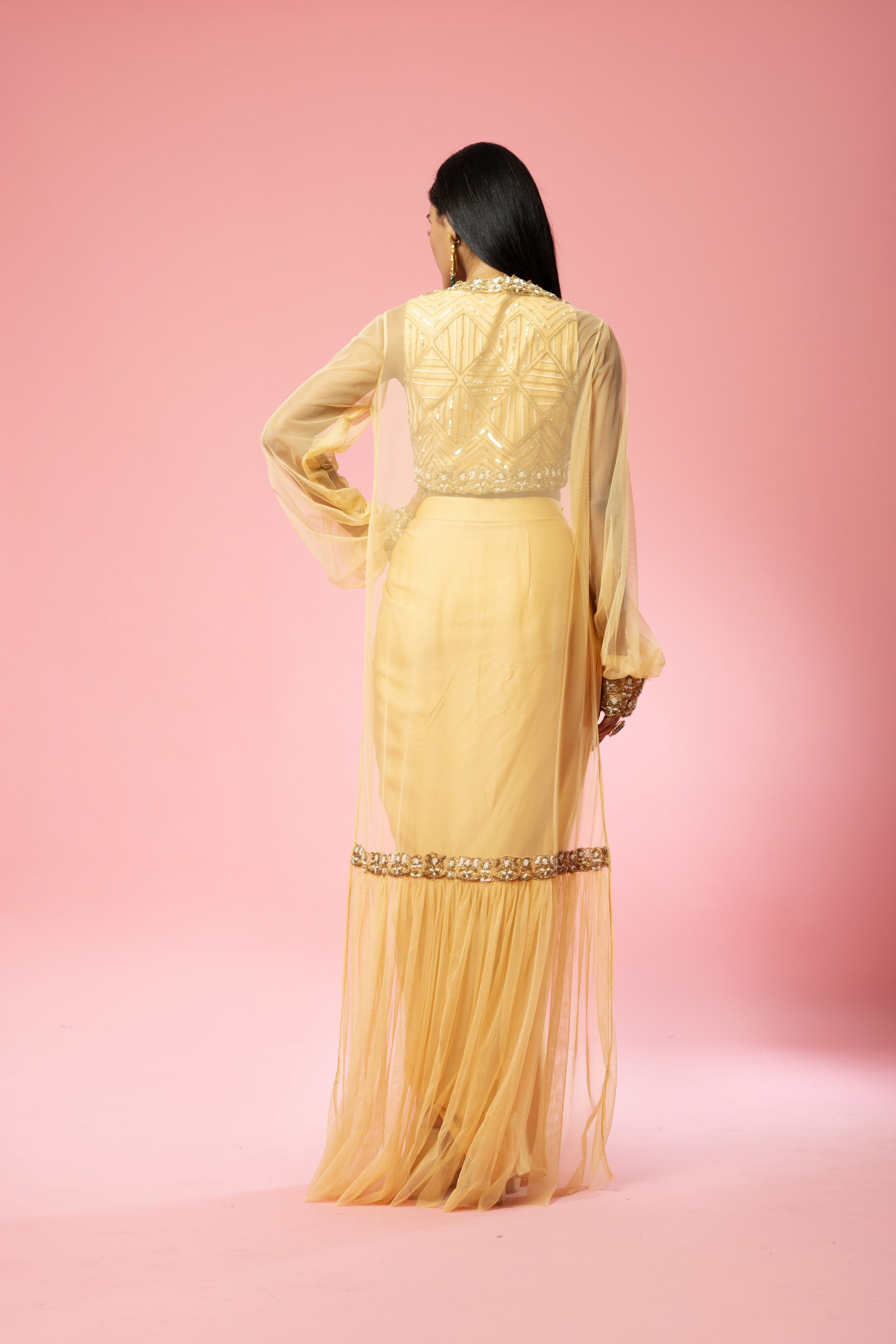 Golden dhoti set with hand-embroidered blouse and cape.