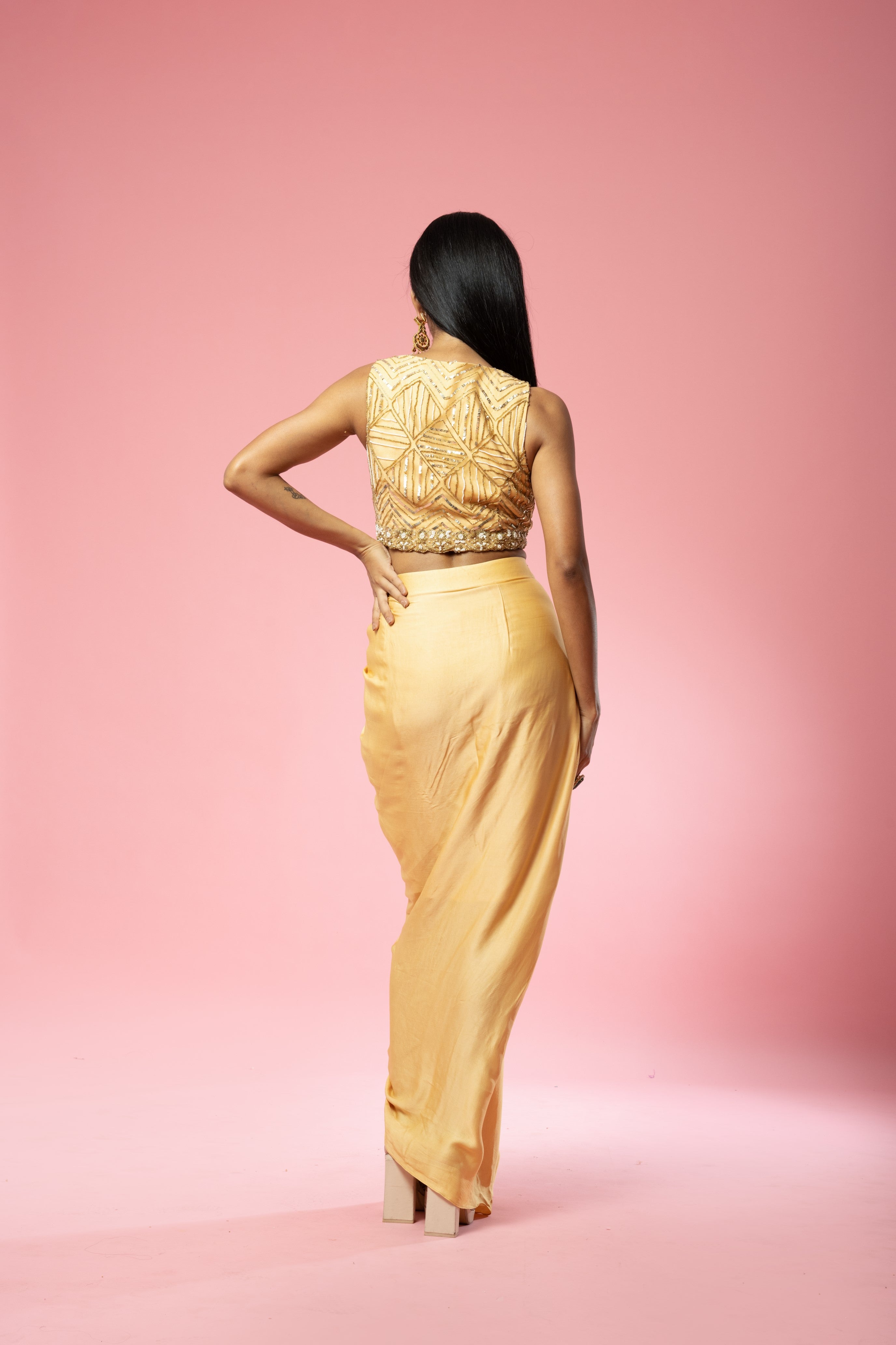 Golden dhoti set with hand-embroidered blouse and cape.