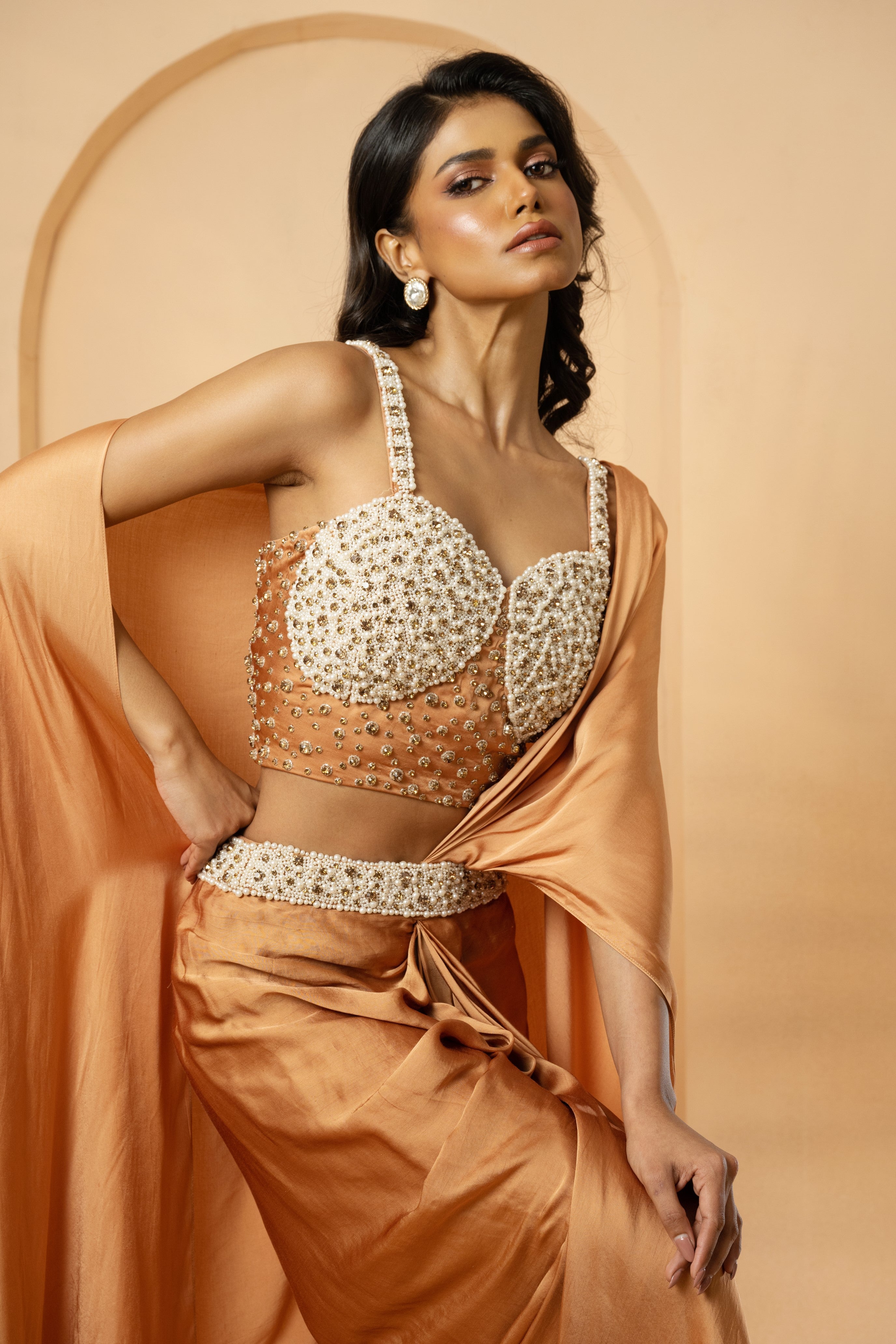 Golden pre-stitched corset saree with intricate embroidery.