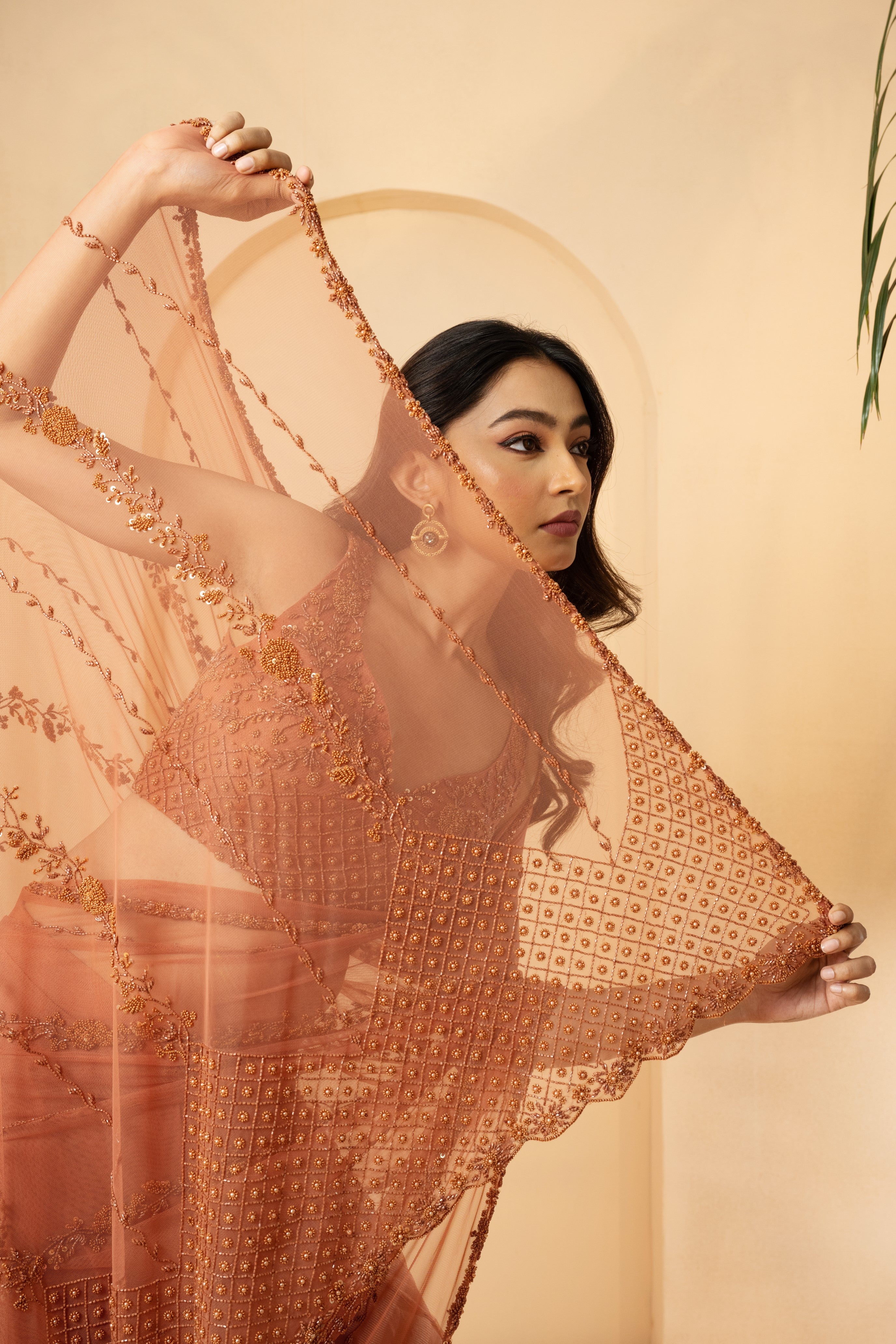 Dust pink pre-stitched drape saree with embroidered blouse and pallu.