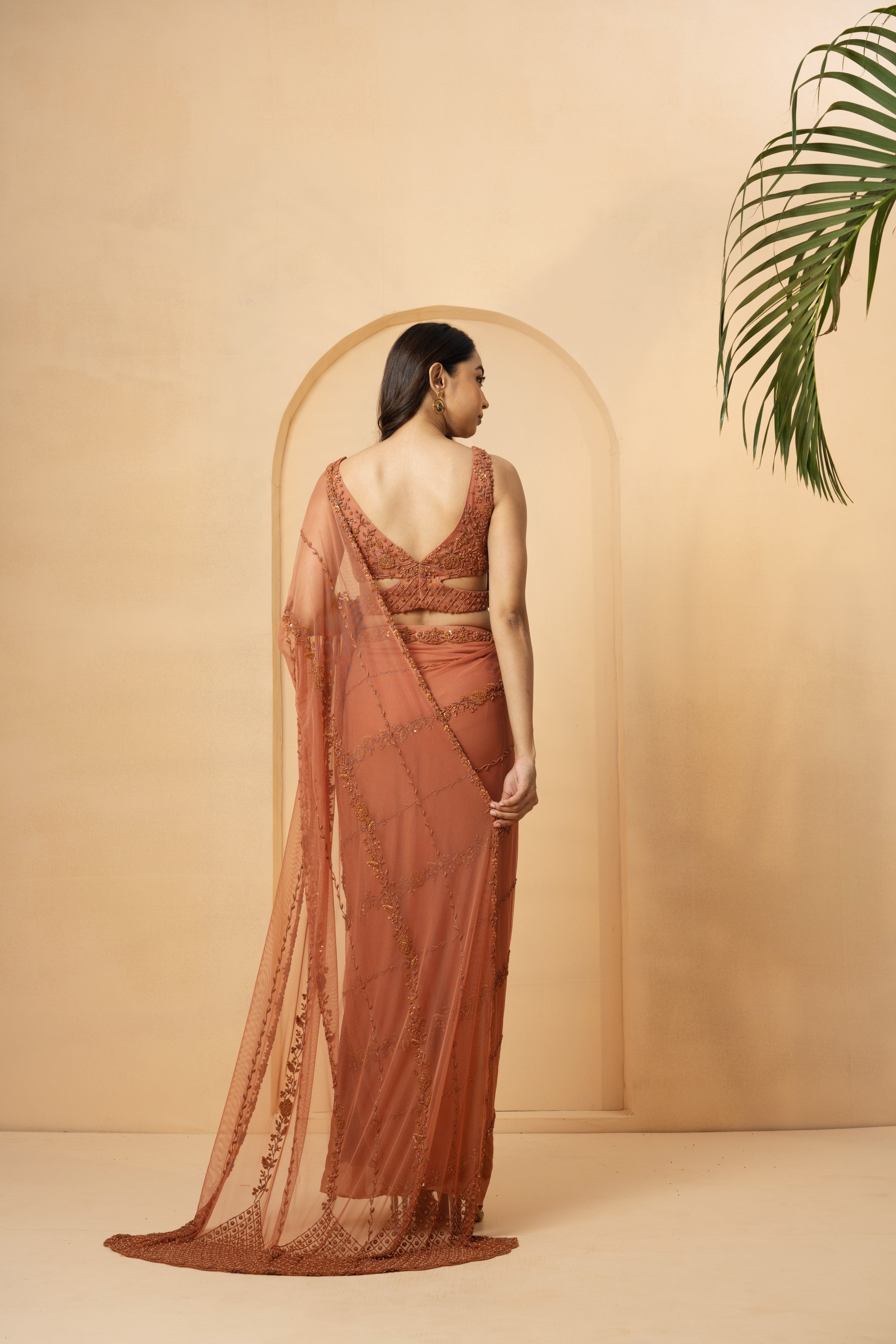 Dust pink pre-stitched drape saree with embroidered blouse and pallu.