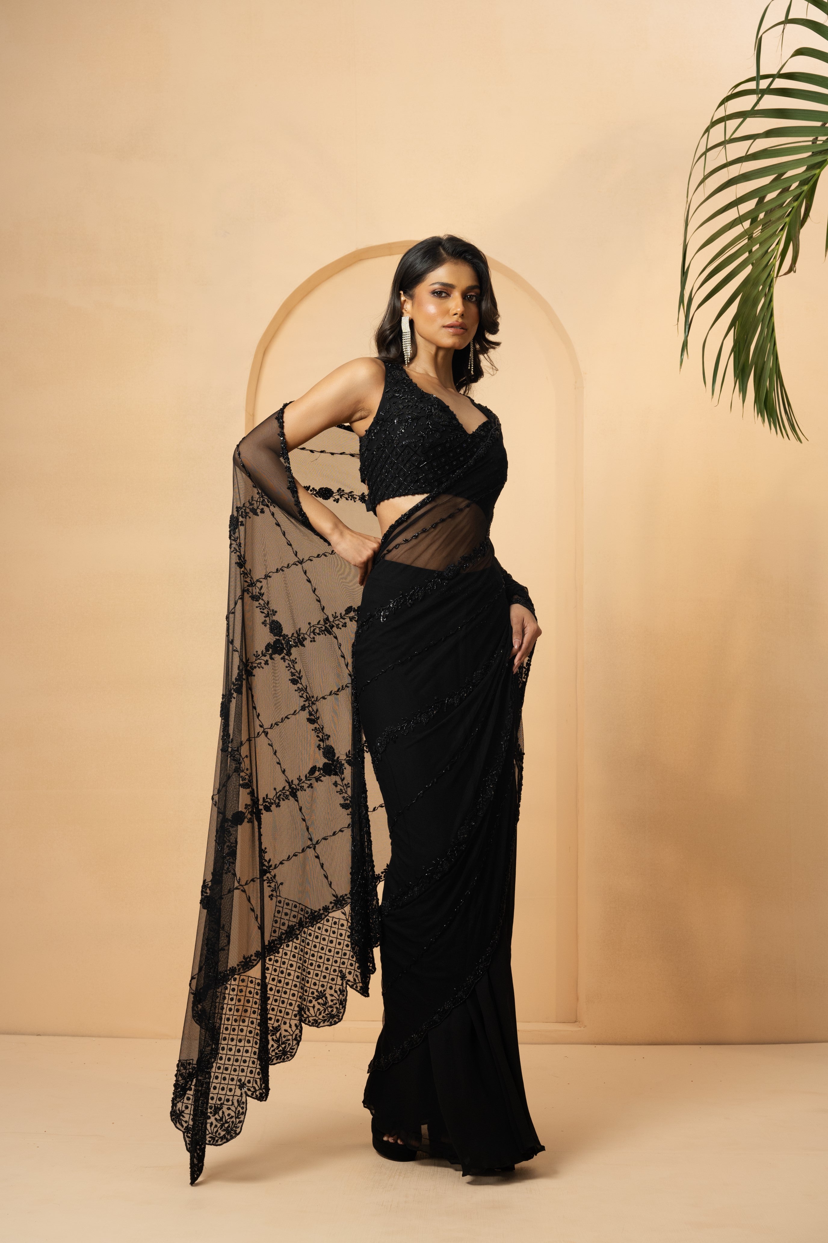 Black pre-stitched saree with embroidered blouse and pallu detailing.