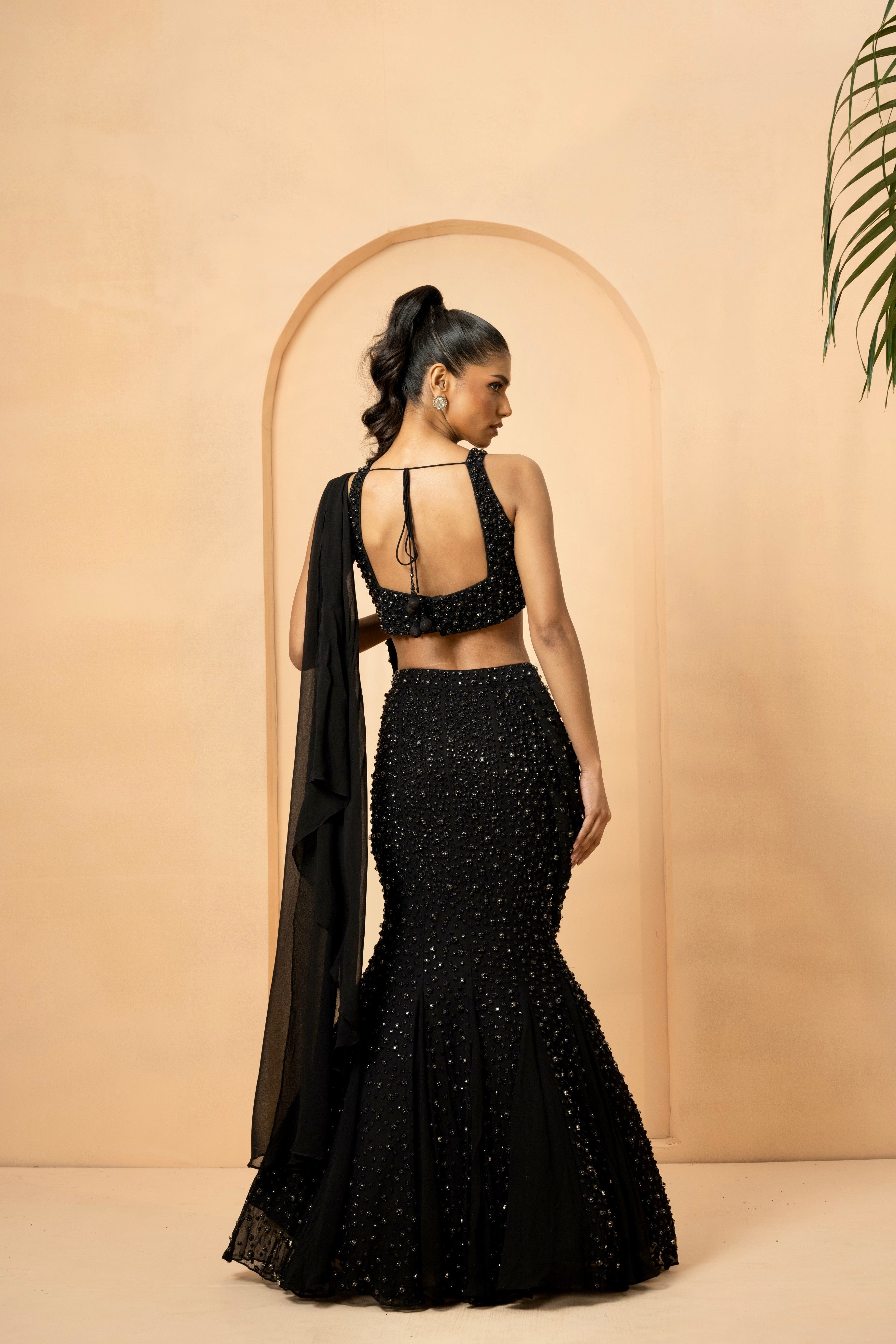Black fishtail lehenga with crystal-stone embroidery and attached dupatta.