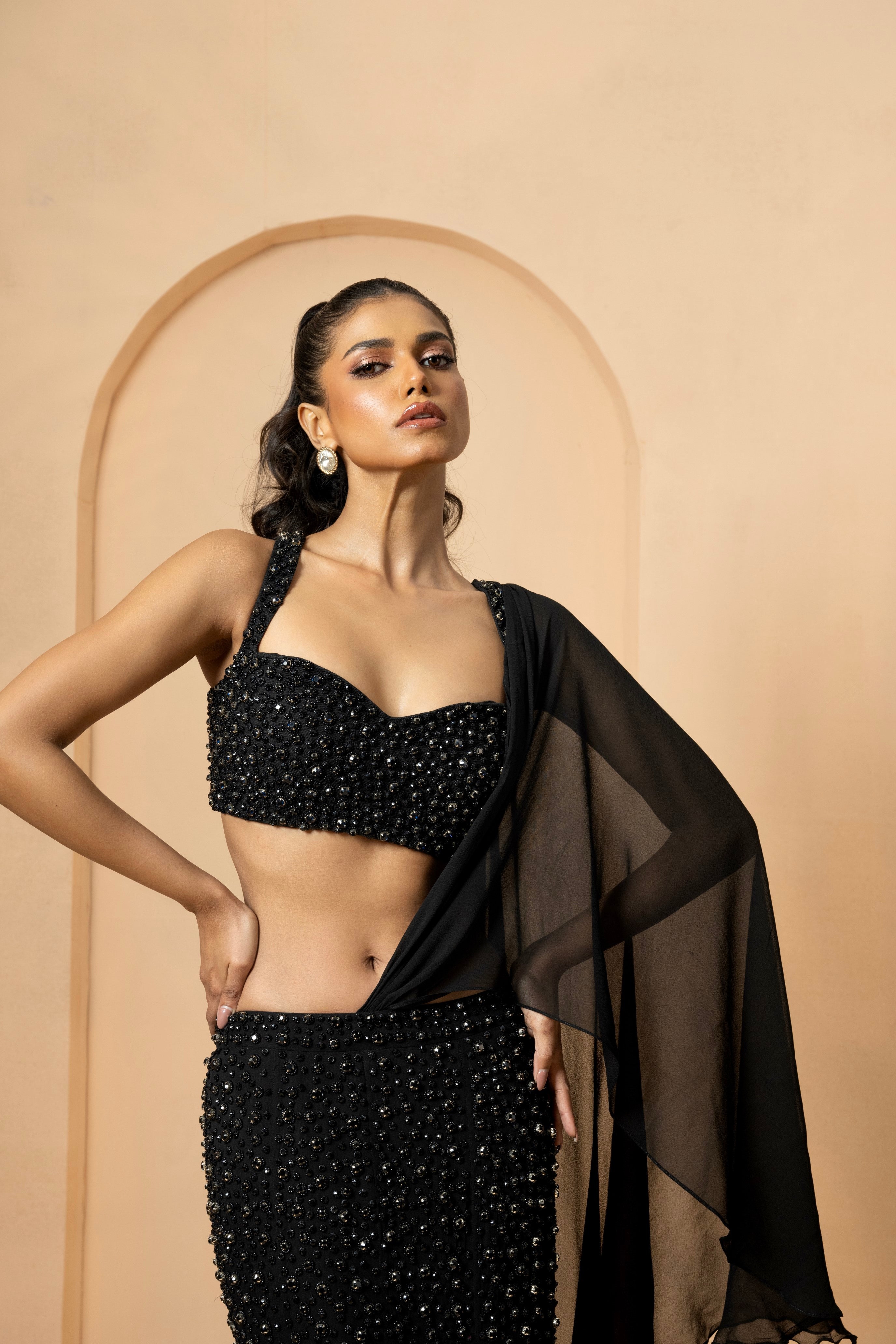 Black fishtail lehenga with crystal-stone embroidery and attached dupatta.