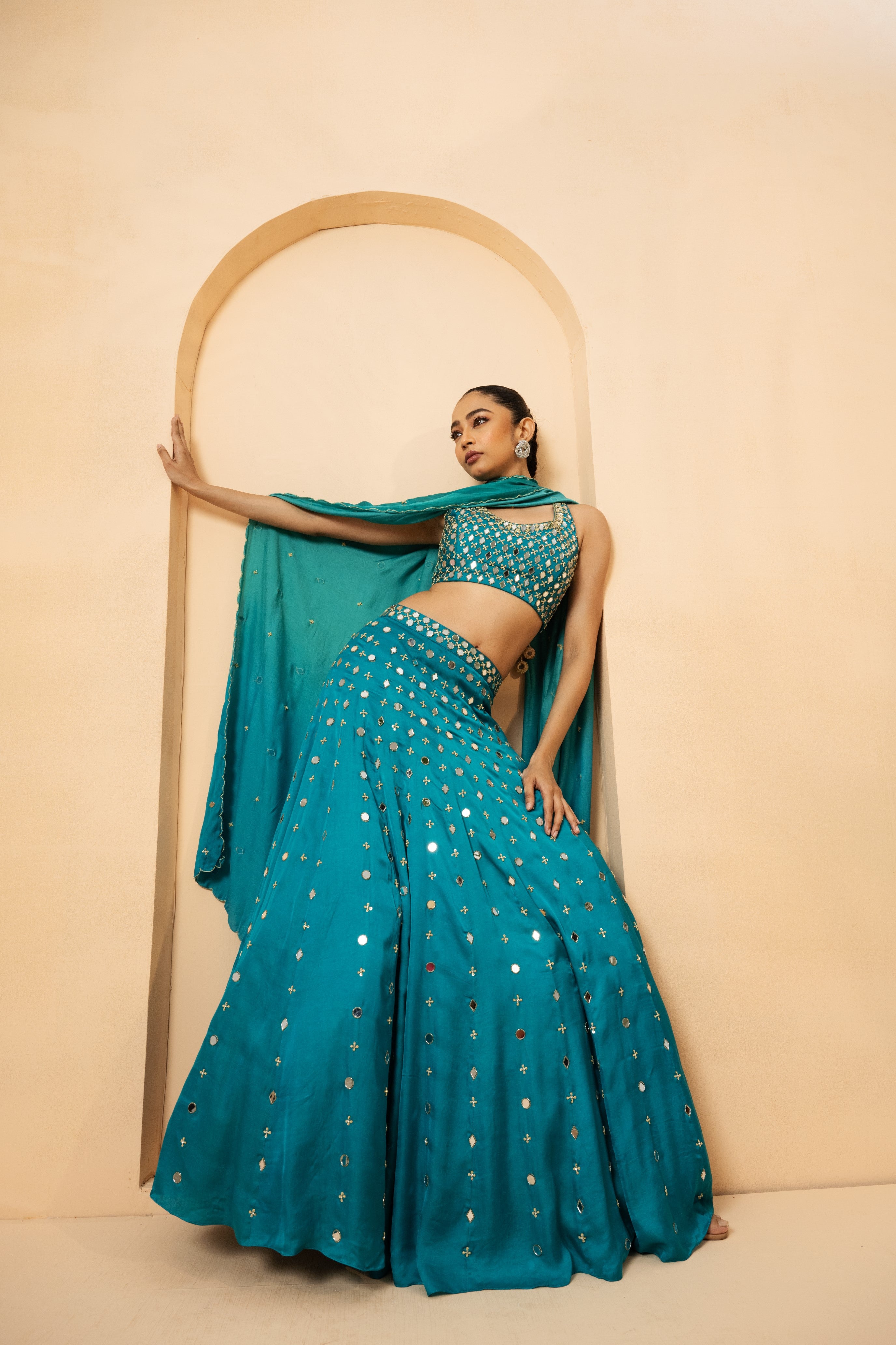 Turquoise mirror lehenga set with pearl beadwork and matching dupatta.