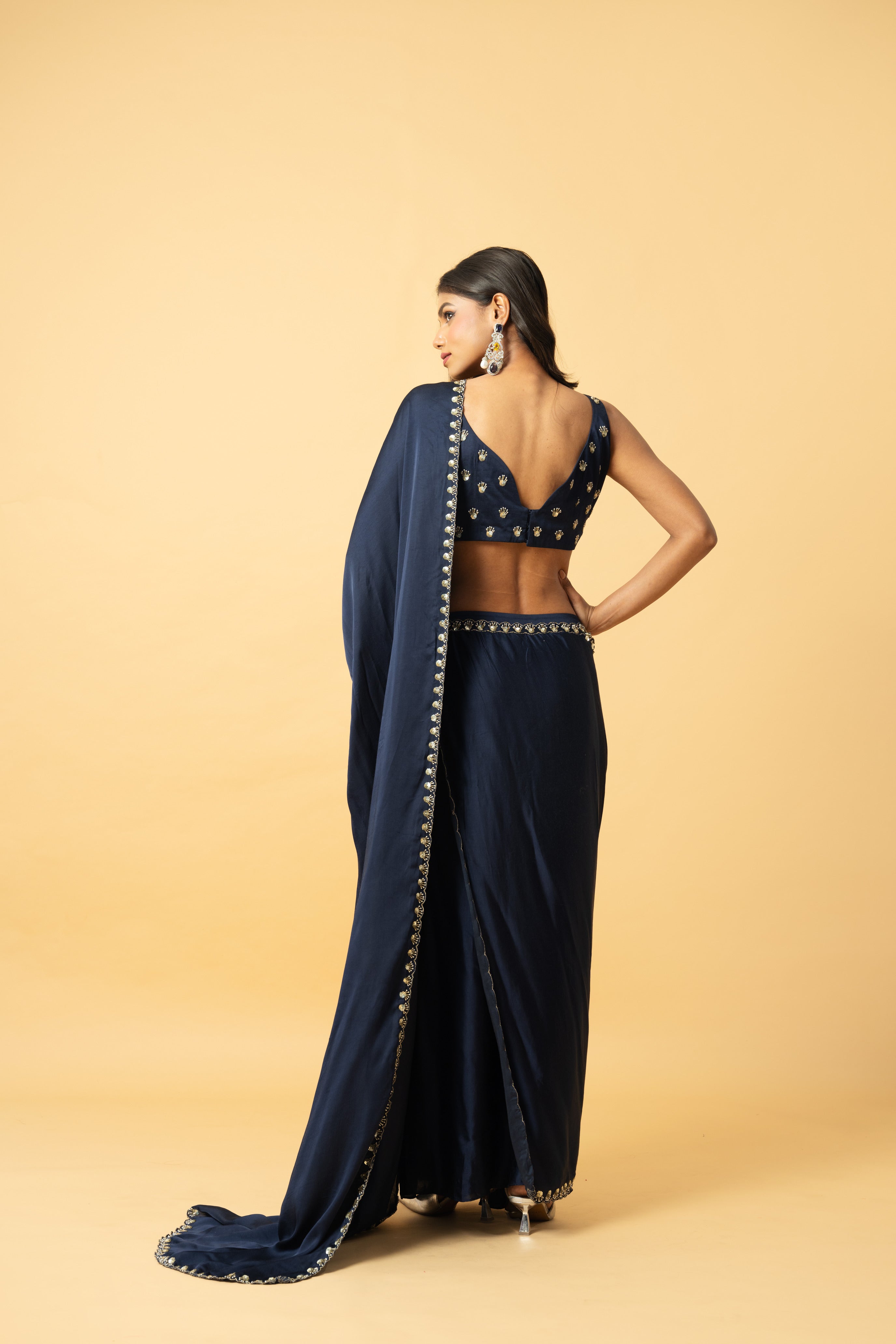 Blue modal satin saree with a hand-embroidered sleeveless blouse.