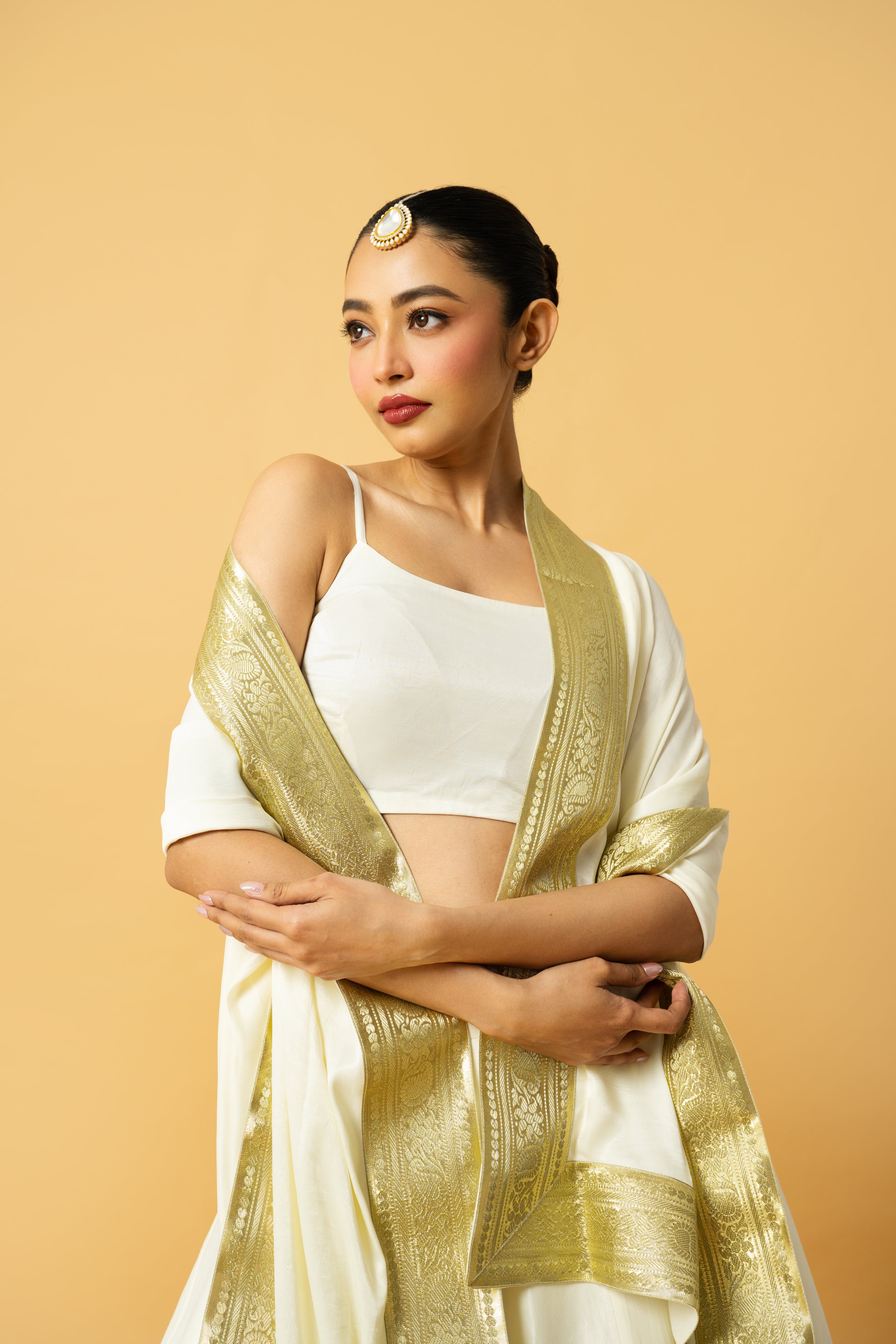 Ivory modal satin lehenga with a golden lace dupatta and latkan details.