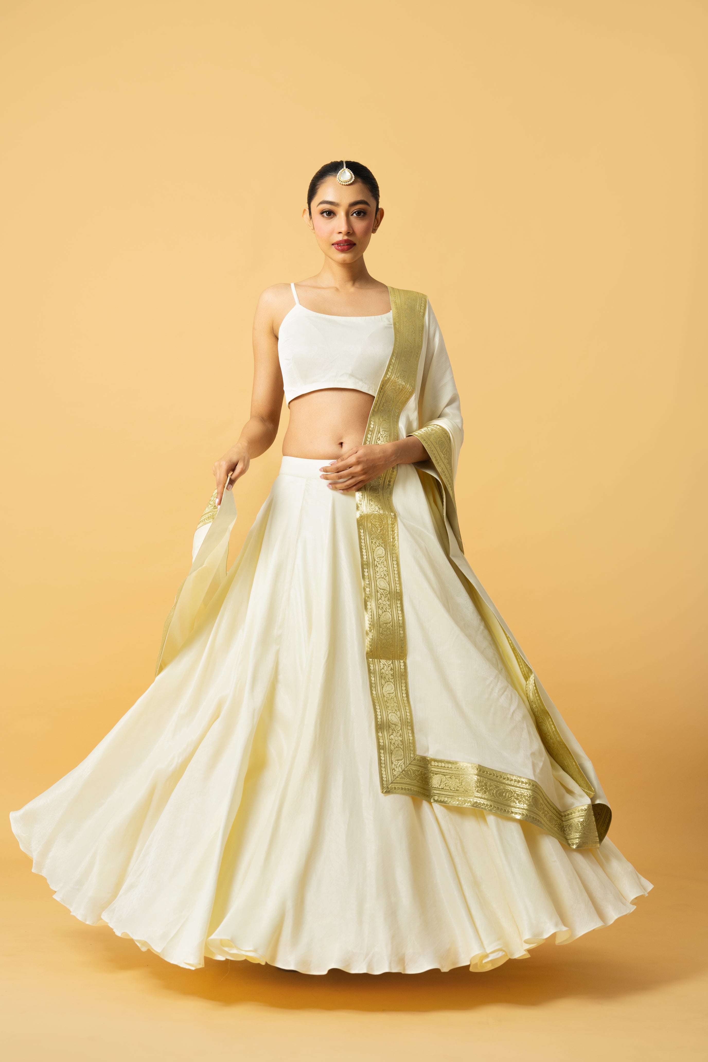 Ivory modal satin lehenga with a golden lace dupatta and latkan details.