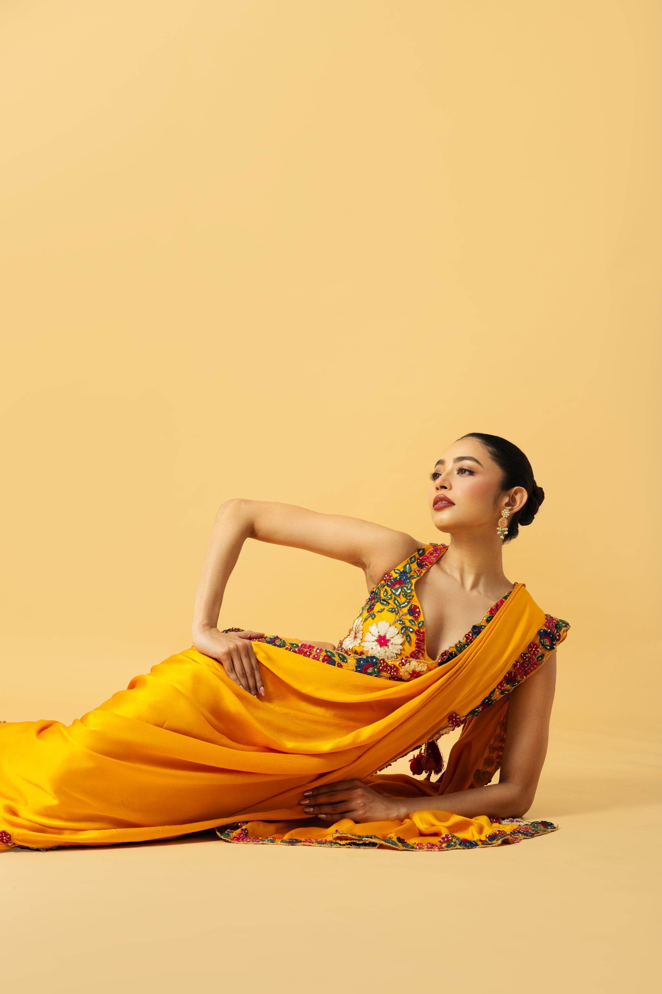Golden yellow saree with multi-colored 3D hand embroidery.