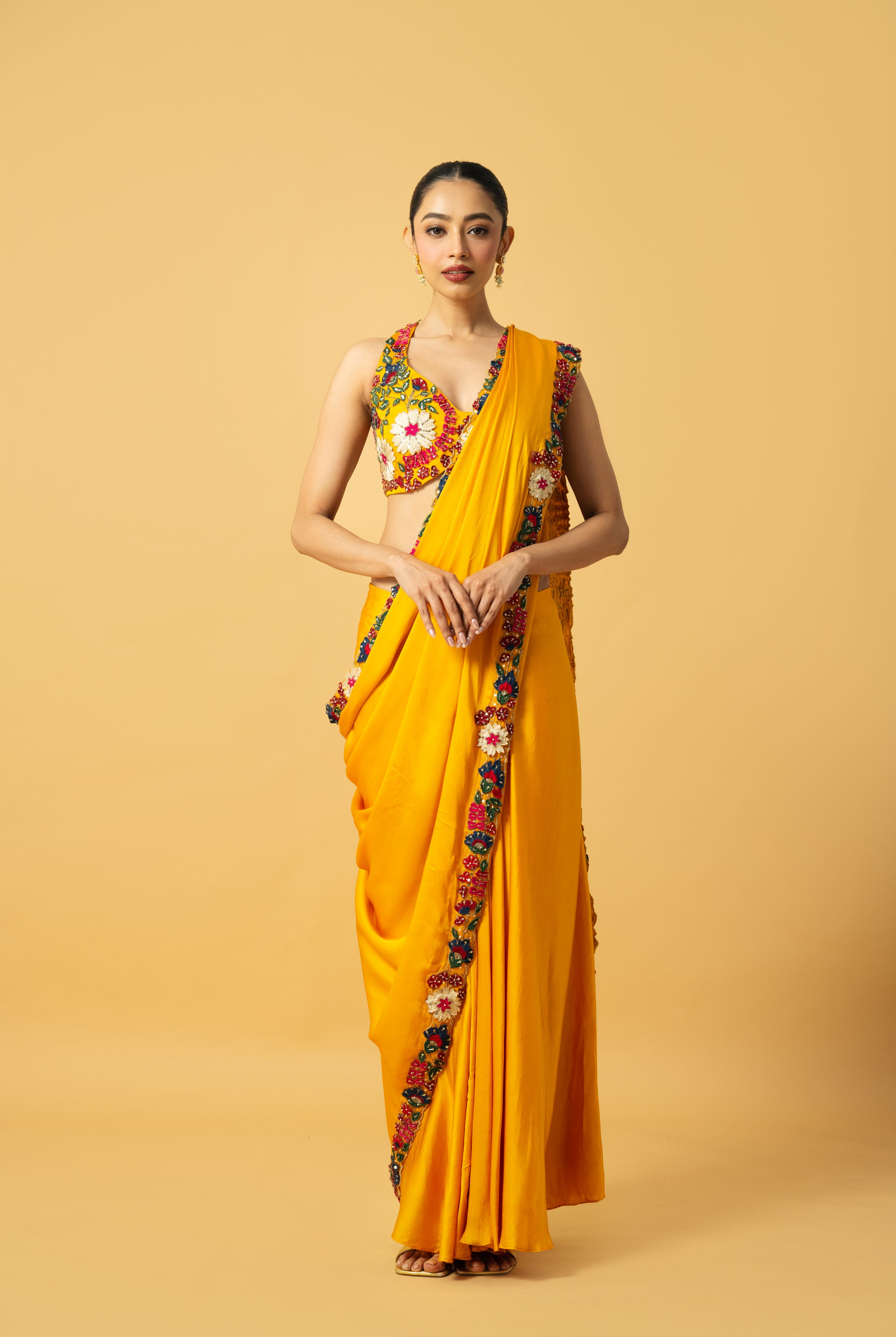 Golden yellow saree with multi-colored 3D hand embroidery.