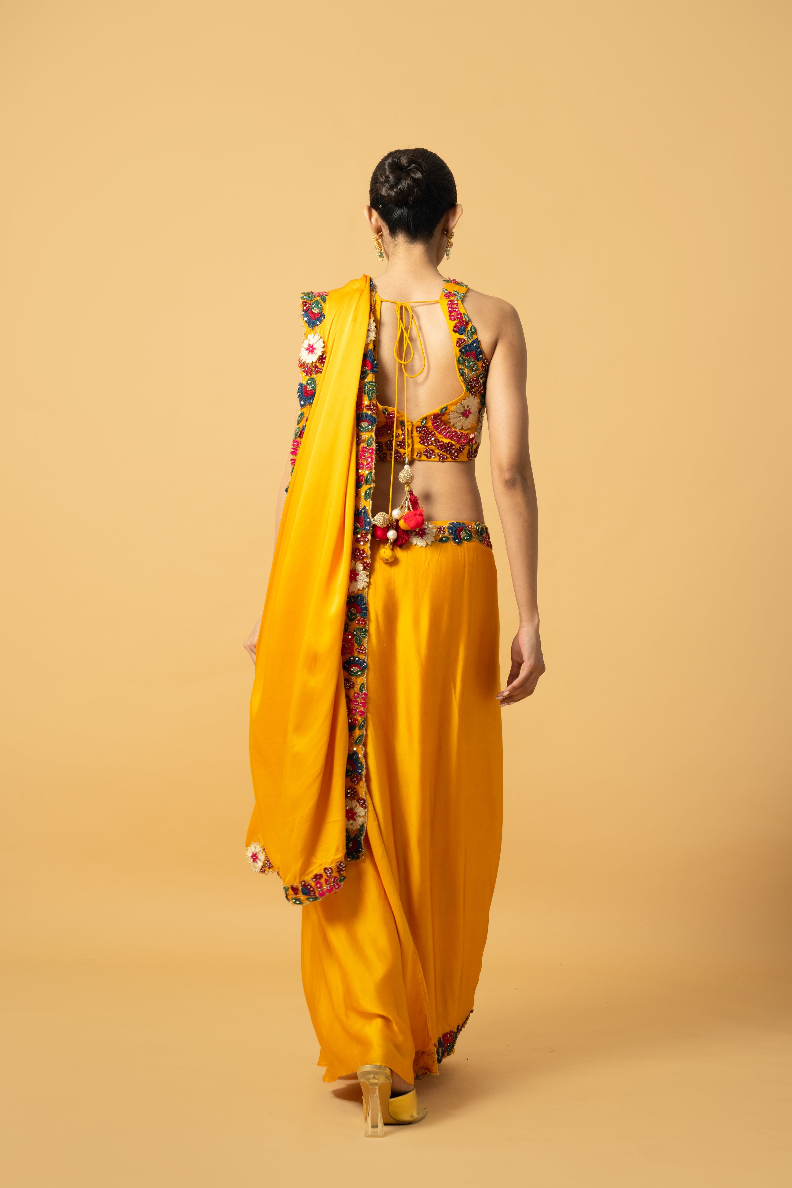 Golden yellow saree with multi-colored 3D hand embroidery.