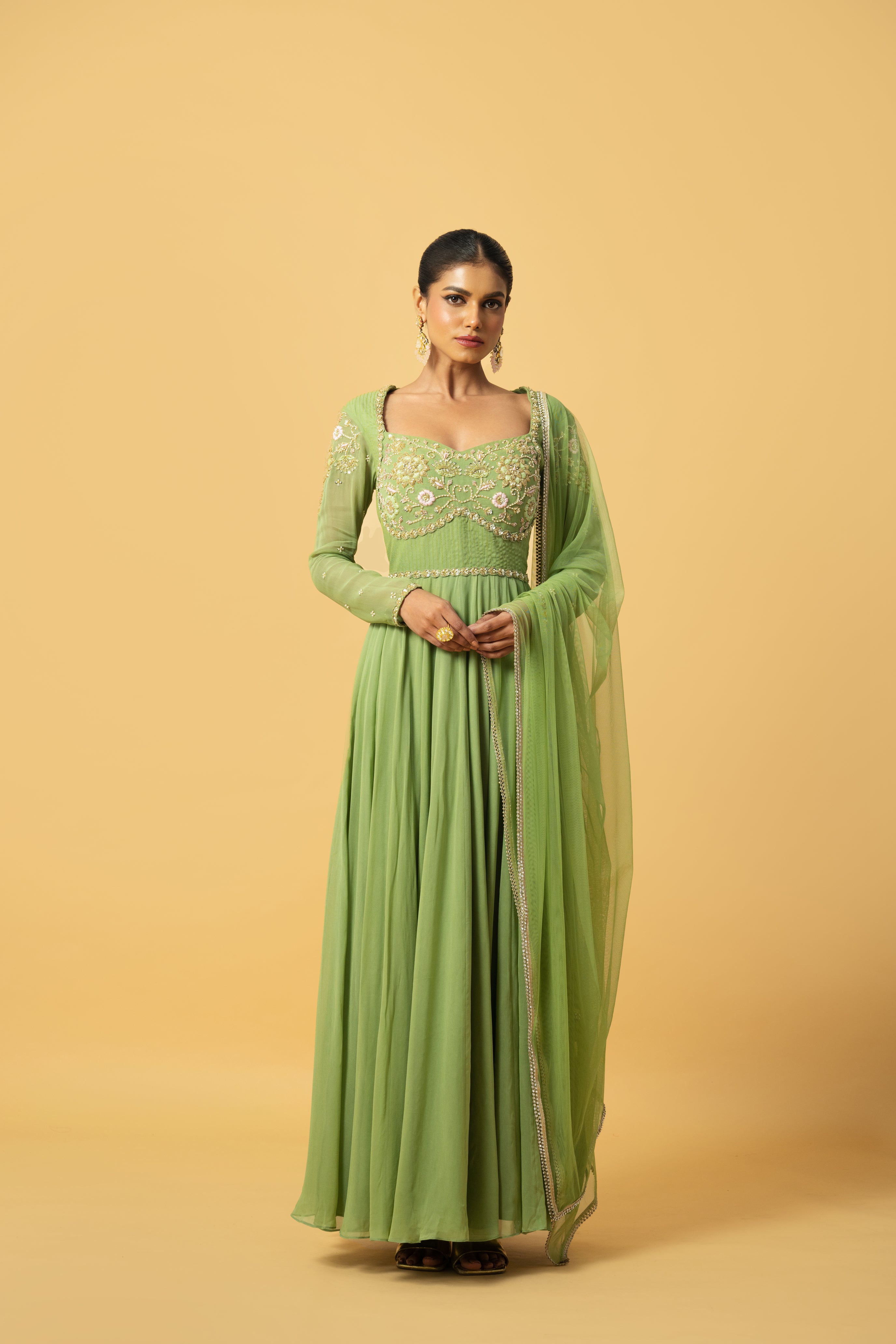 Mint green georgette Anarkali with intricate embroidery and soft net dupatta.