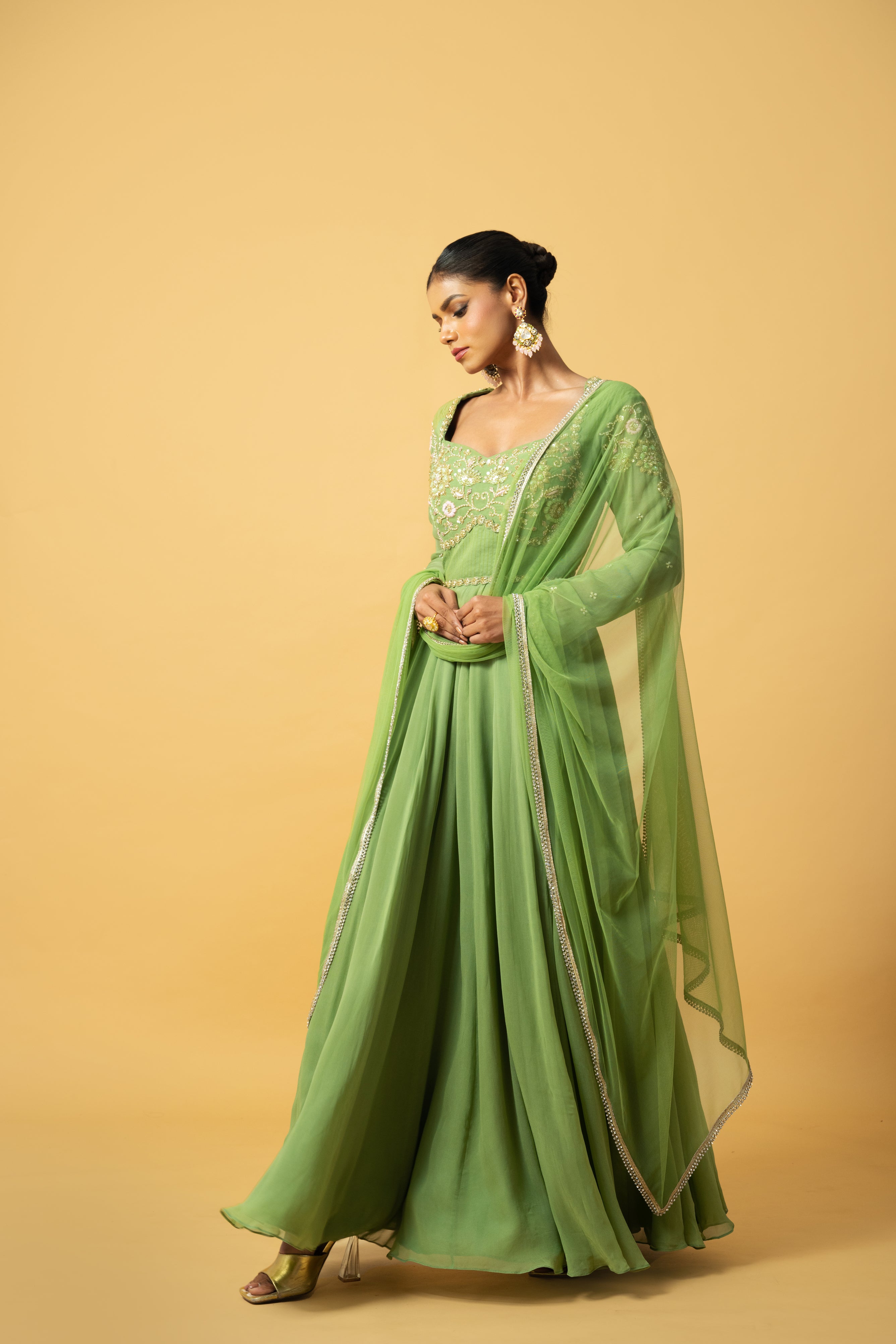 Mint green georgette Anarkali with intricate embroidery and soft net dupatta.