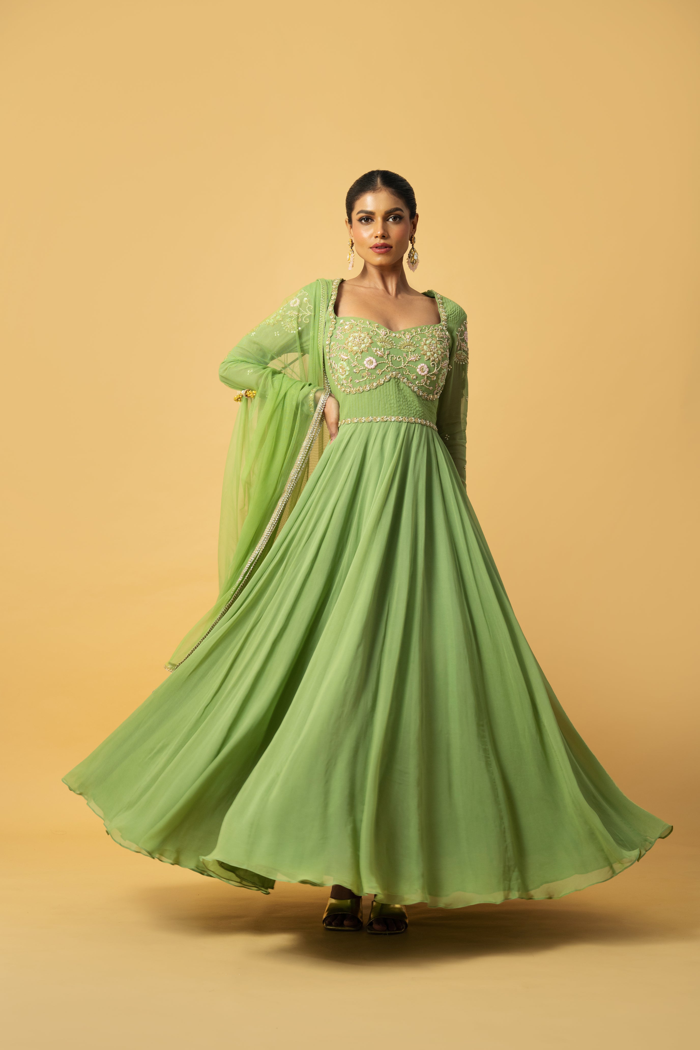 Mint green georgette Anarkali with intricate embroidery and soft net dupatta.