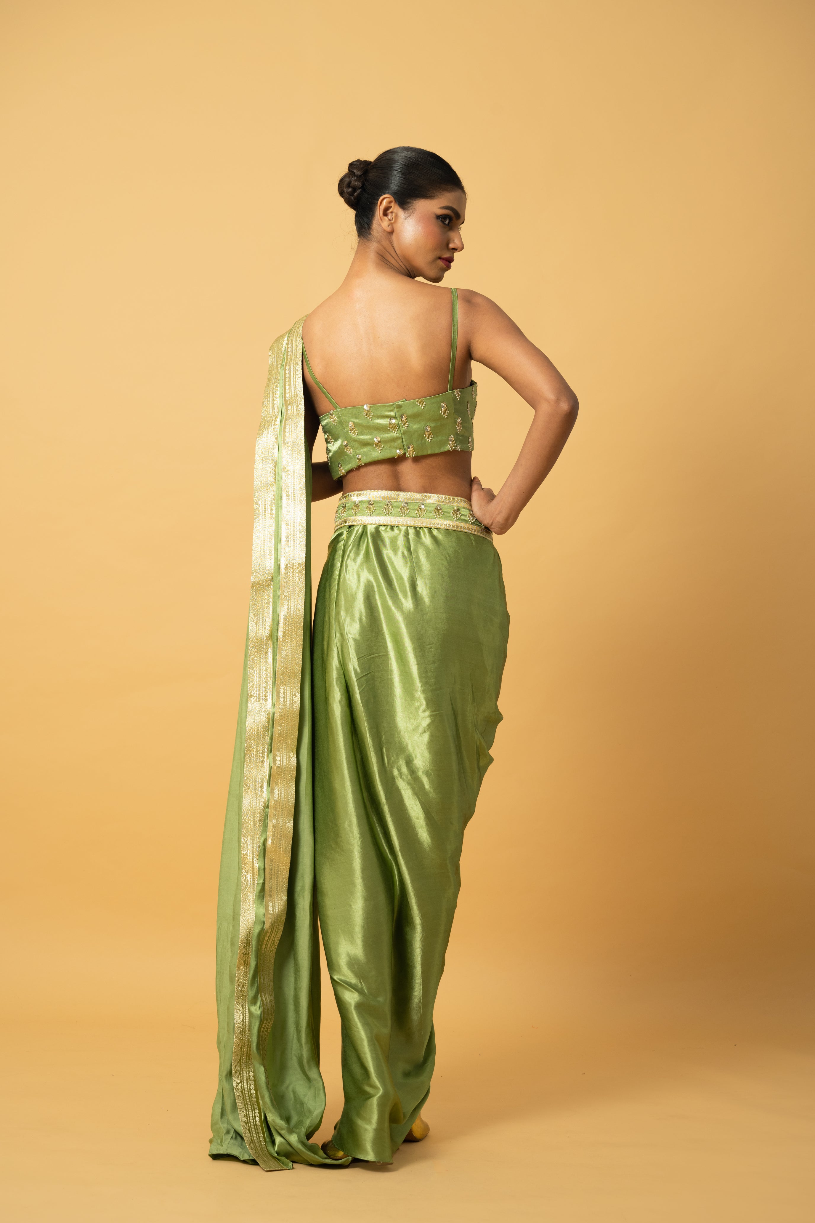 Bright mint green dhoti saree with golden lace and embroidered blouse.