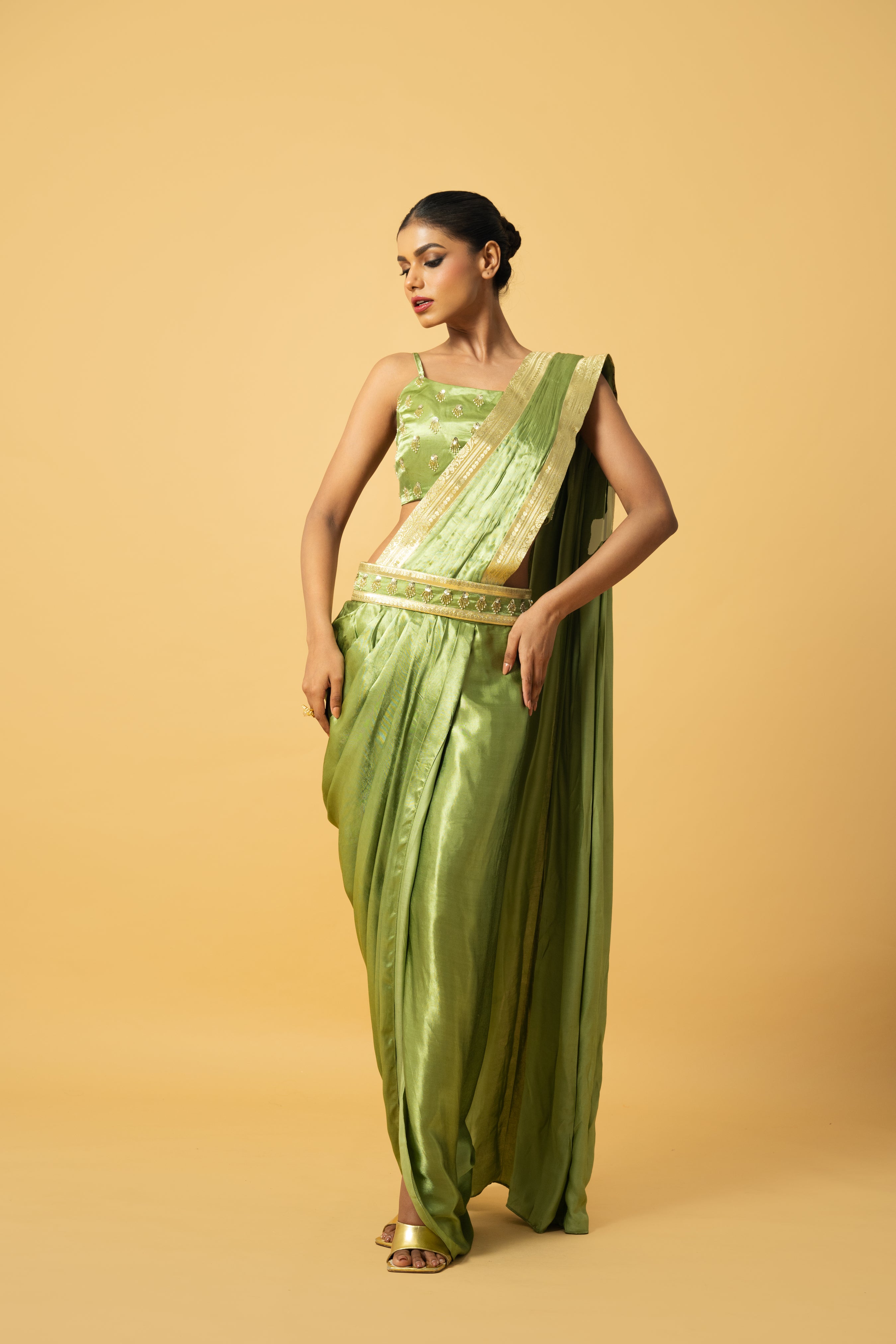 Bright mint green dhoti saree with golden lace and embroidered blouse.