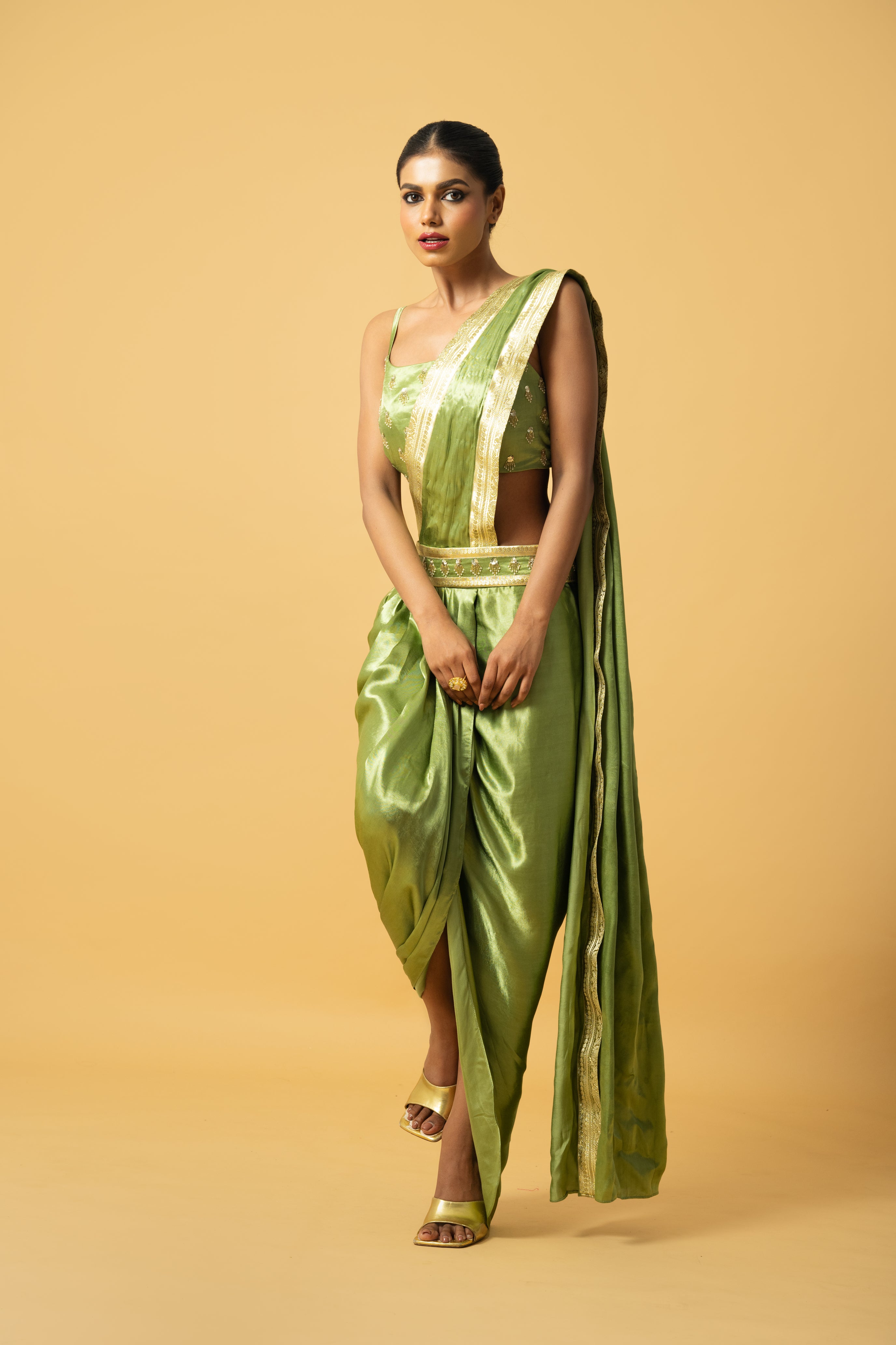 Bright mint green dhoti saree with golden lace and embroidered blouse.