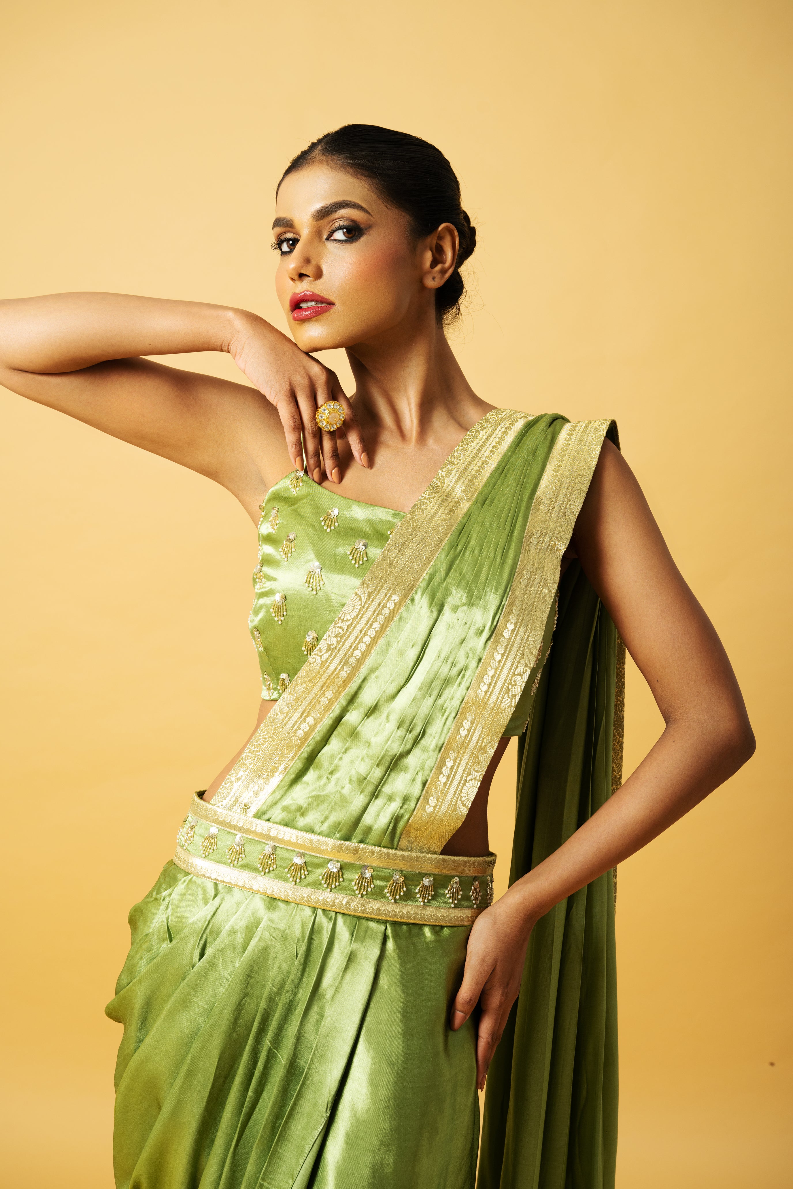 Bright mint green dhoti saree with golden lace and embroidered blouse.