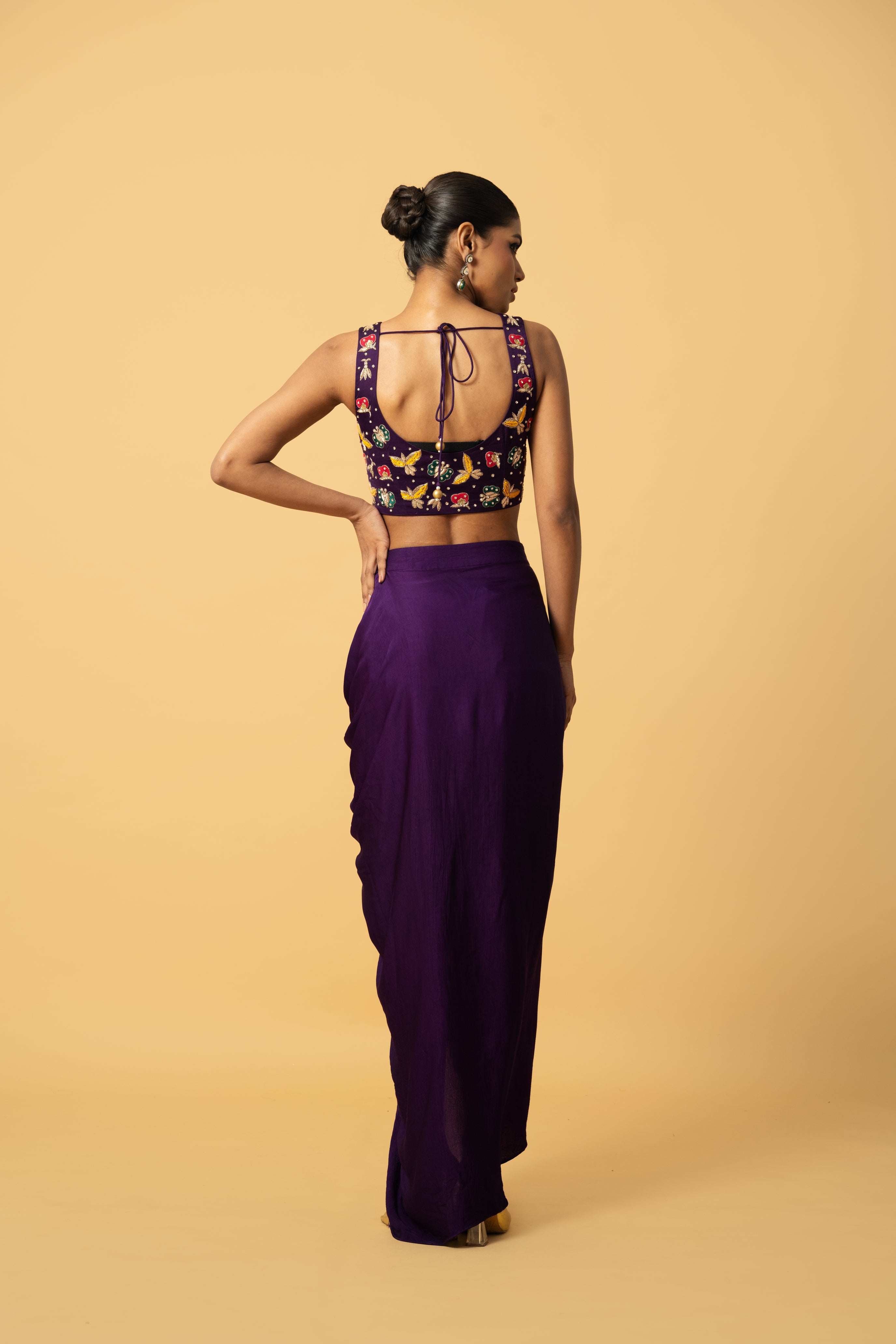 Violet co-ord set with multi-colored hand embroidery and a georgette cape.