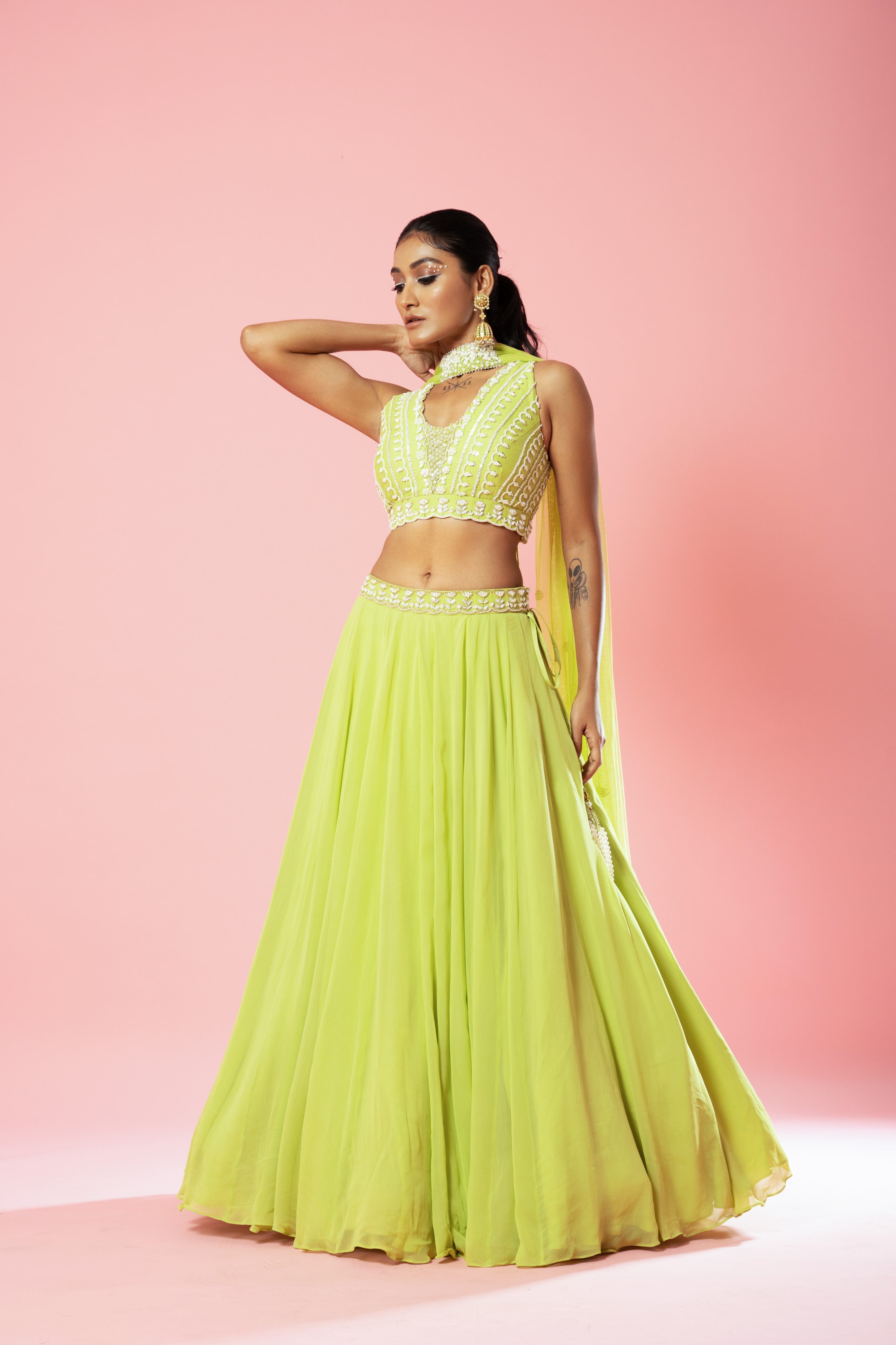 Lime green georgette lehenga with hand embroidery and a choker-style dupatta.