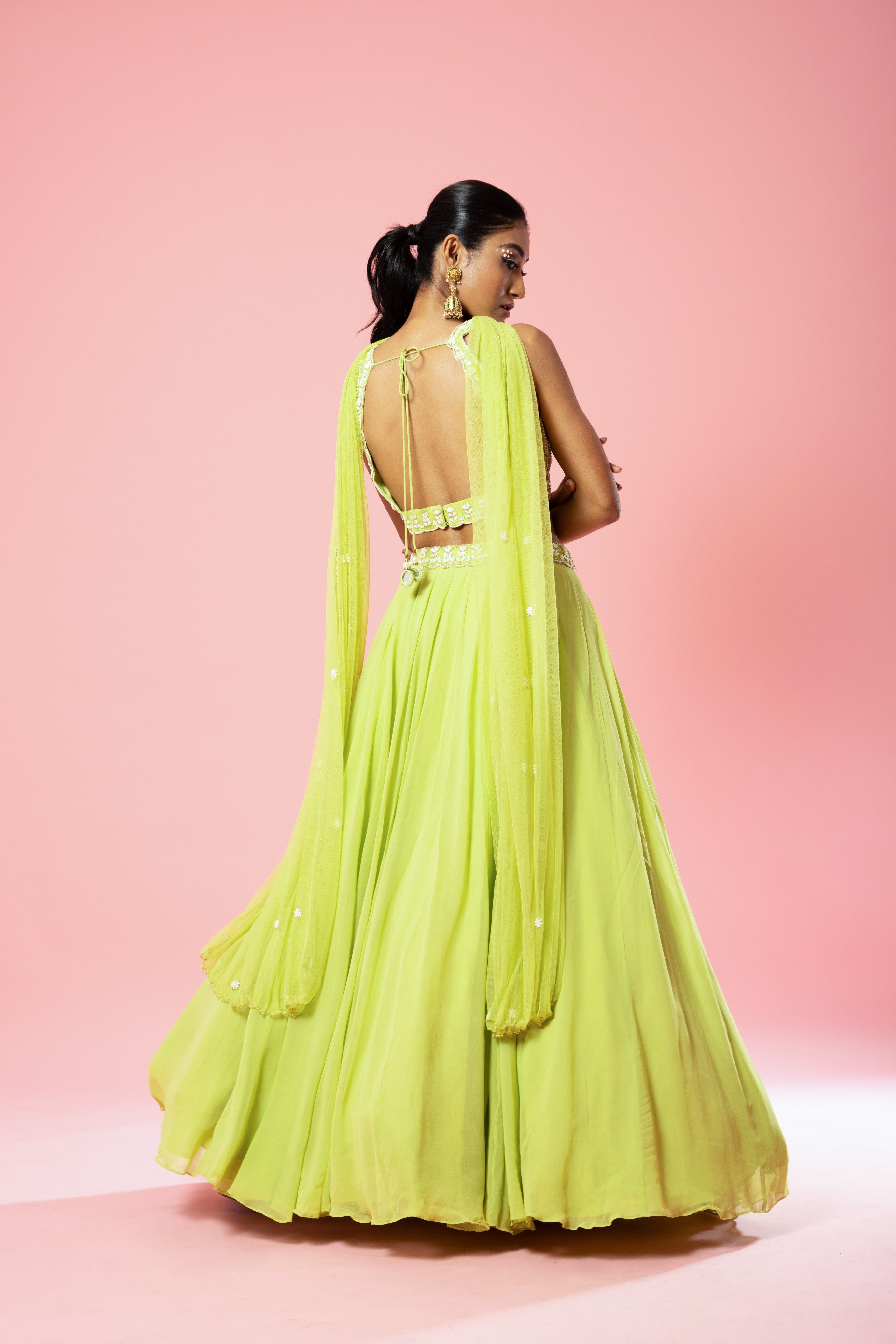 Lime green georgette lehenga with hand embroidery and a choker-style dupatta.
