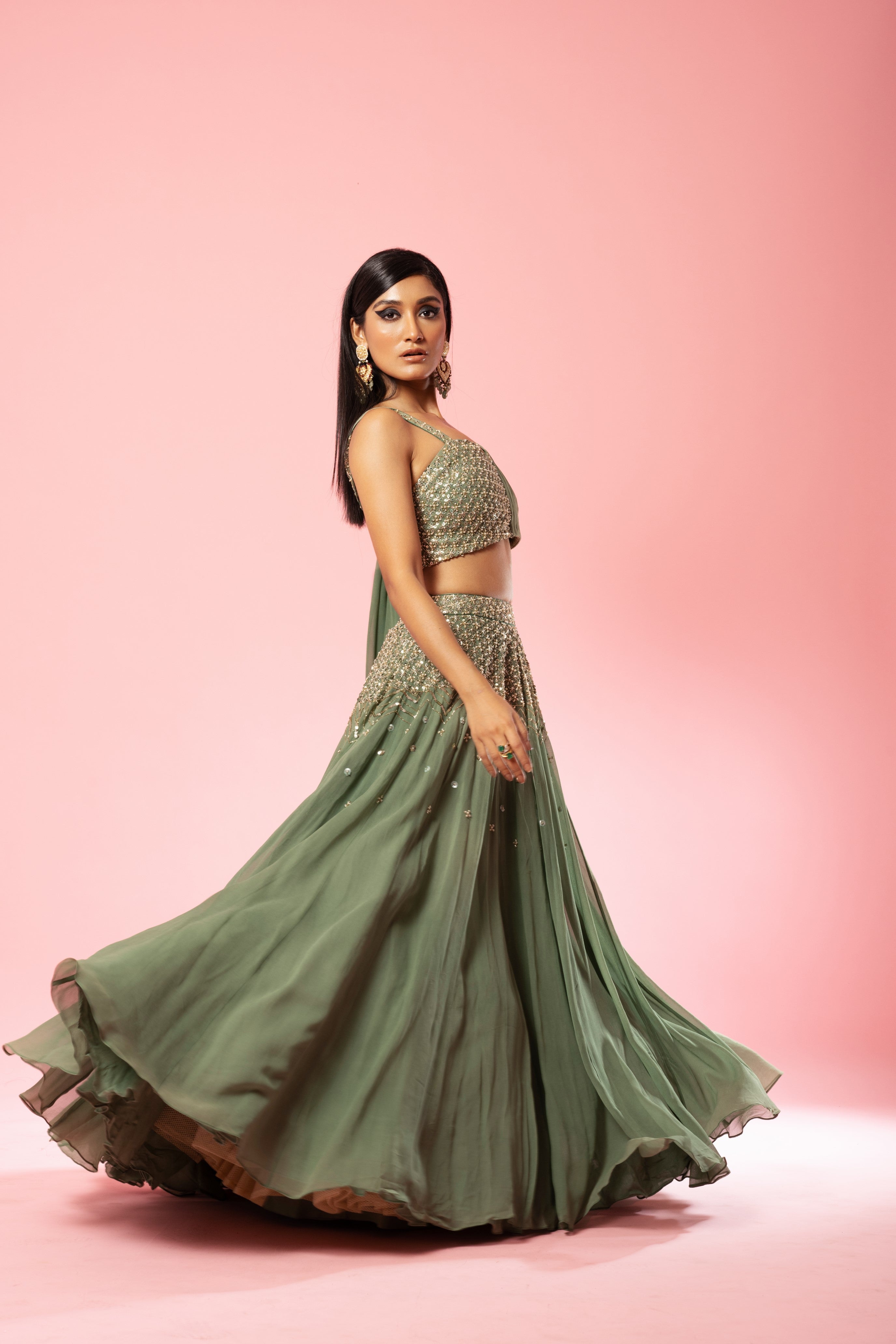 Sage green georgette drape lehenga with hand-embroidered details.