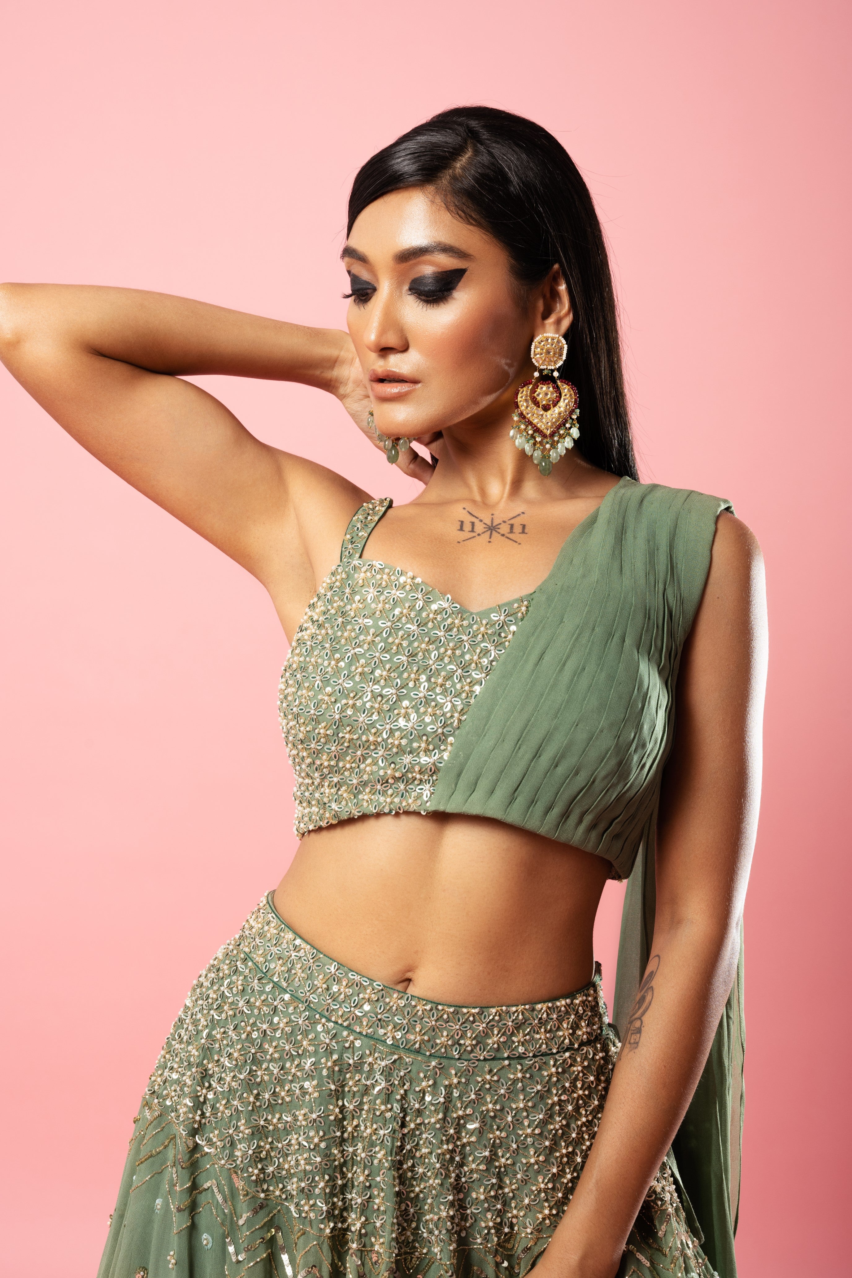 Sage green georgette drape lehenga with hand-embroidered details.