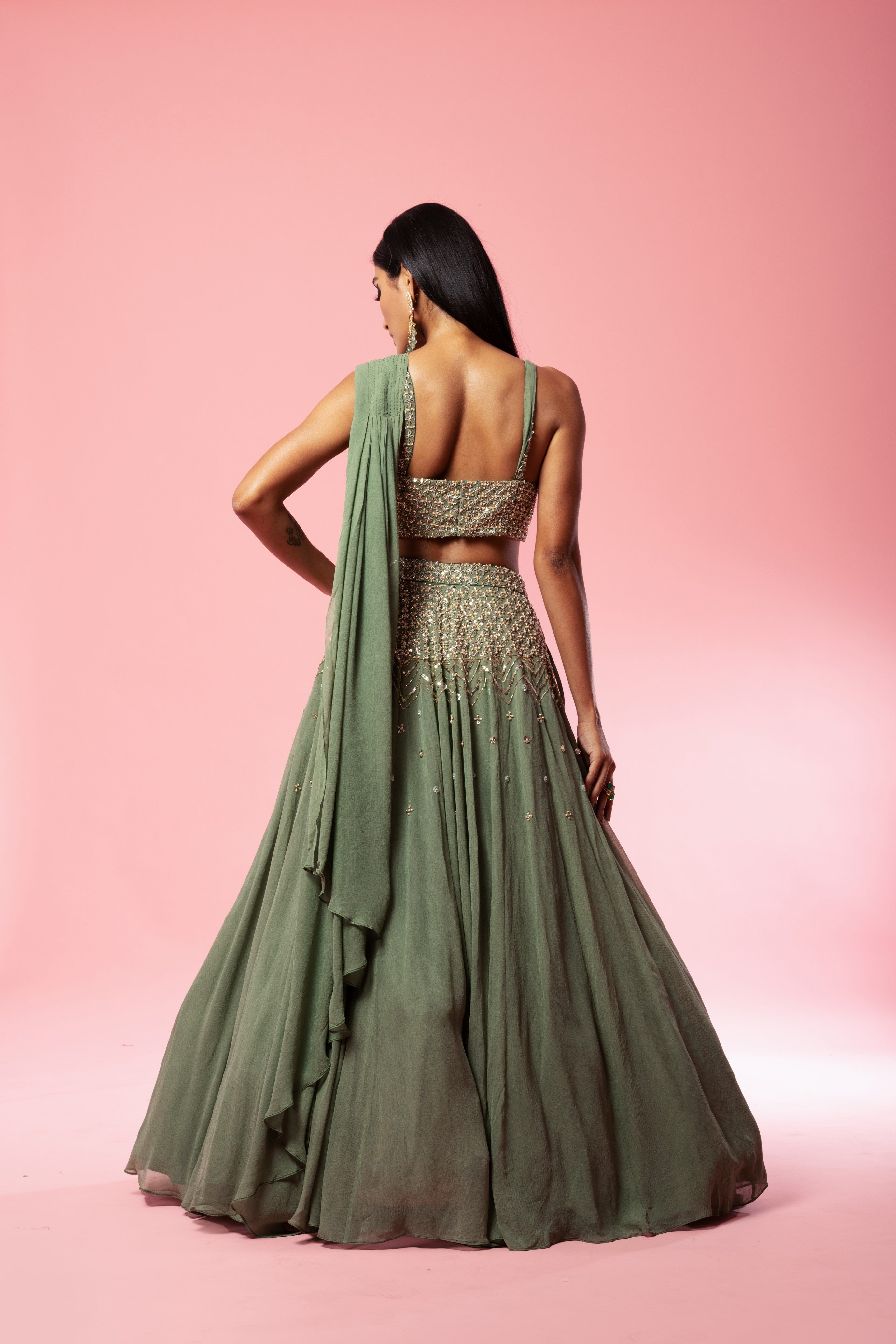Sage green georgette drape lehenga with hand-embroidered details.