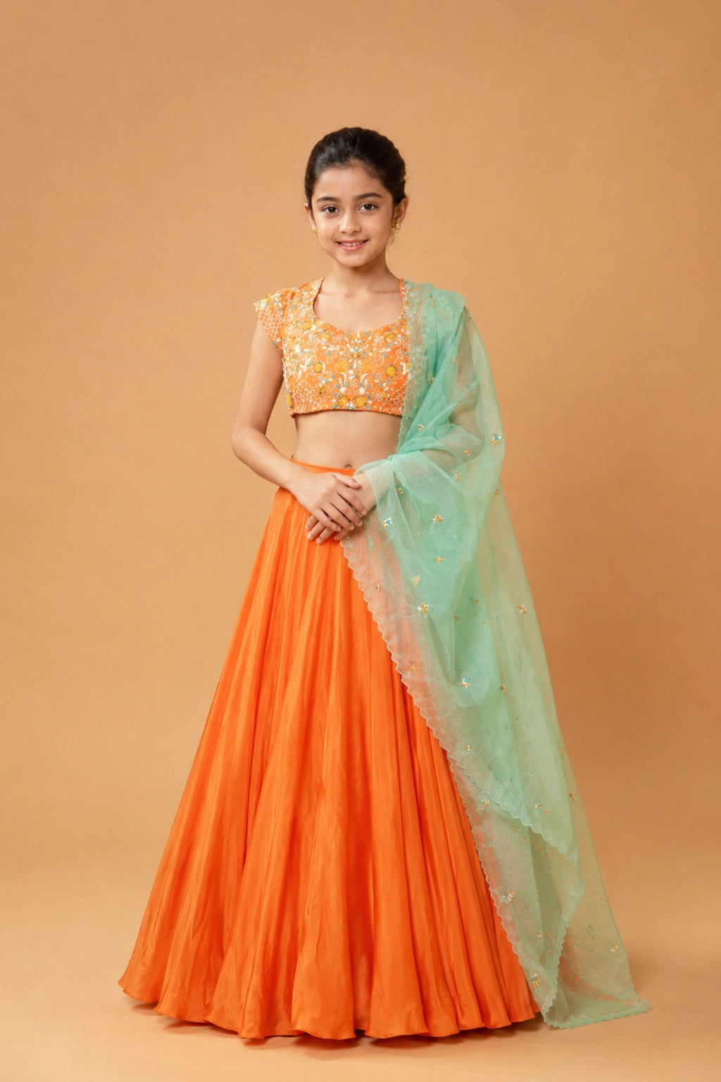 Orange lehenga in modal fabric with intricate handwork on the blouse and dupatta, including kardana, moti, stones, and zari.