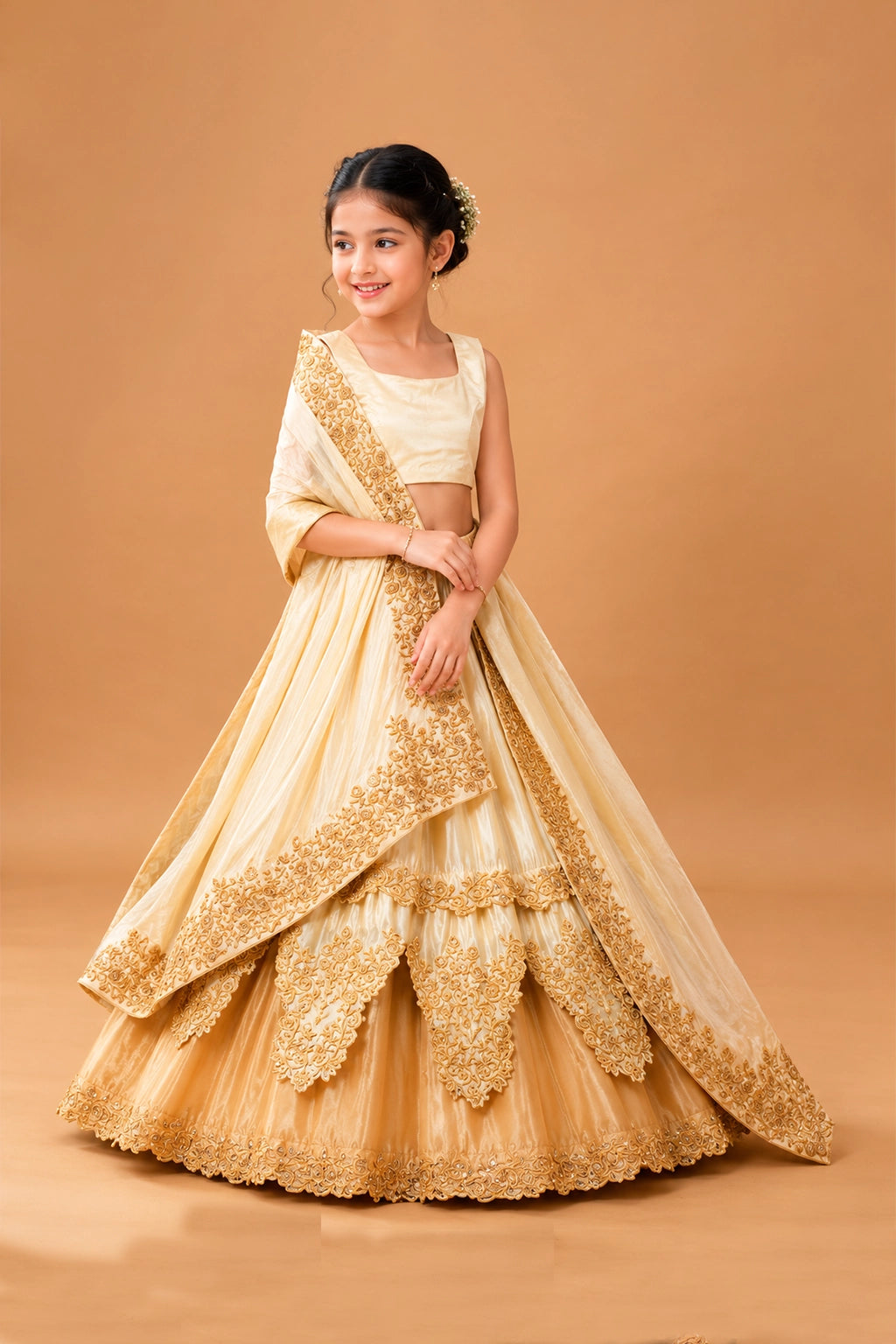 A layered golden ombre lehenga with intricate floral motifs crafted using kardana and zari threadwork.