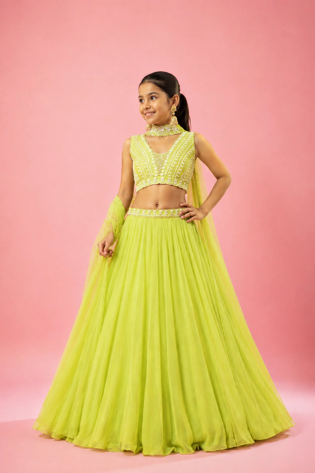 A lime green georgette lehenga featuring intricate hand embroidery on the blouse and belt, paired with a soft net choker-style dupatta.