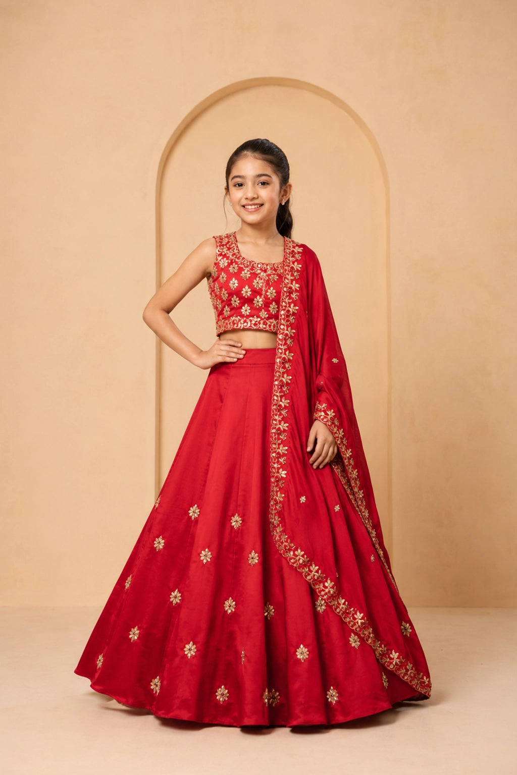 A classic red lehenga crafted in modal silk, adorned with intricate hand embroidery.