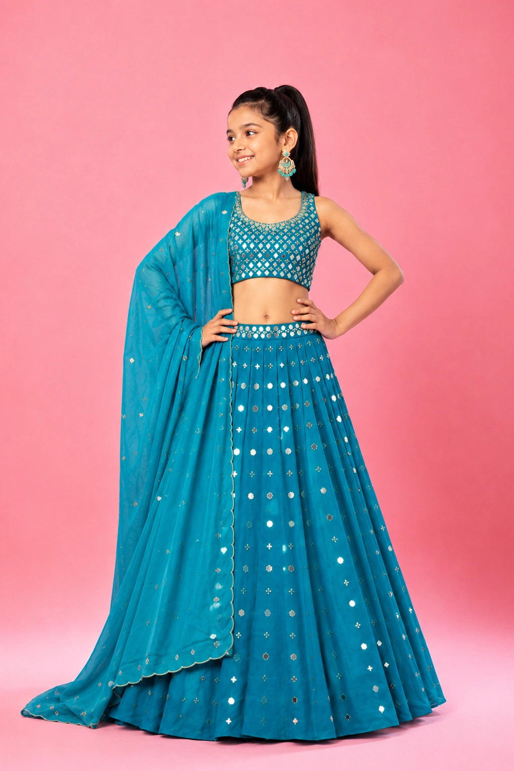 Turquoise lehenga in modal satin fabric, embellished with intricate mirror and pearl beadwork. Paired with a matching blouse and dupatta for a perfect festive look.