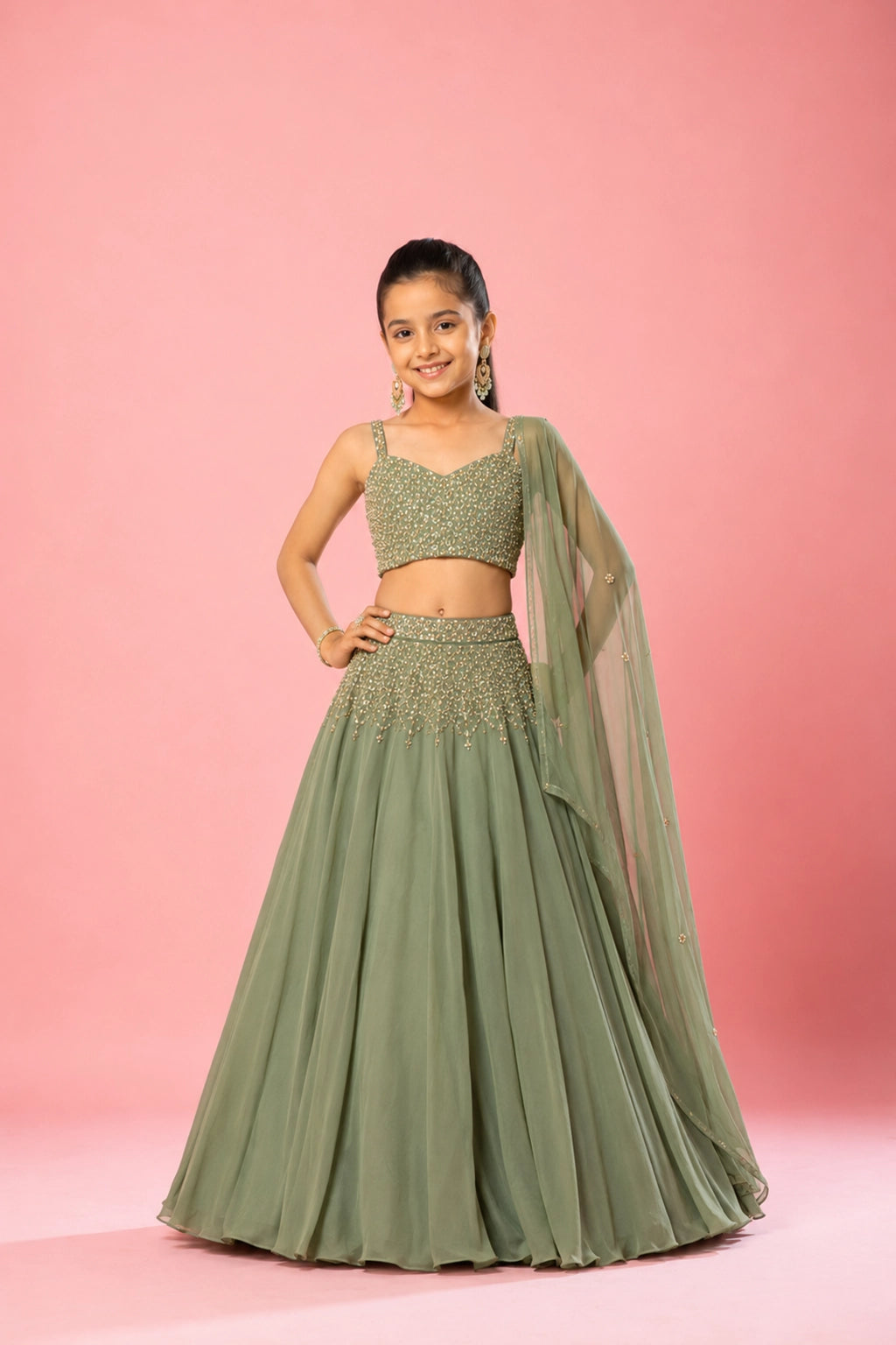 A graceful sage green drape lehenga in pure georgette, with intricate hand embroidery on the blouse and skirt.
