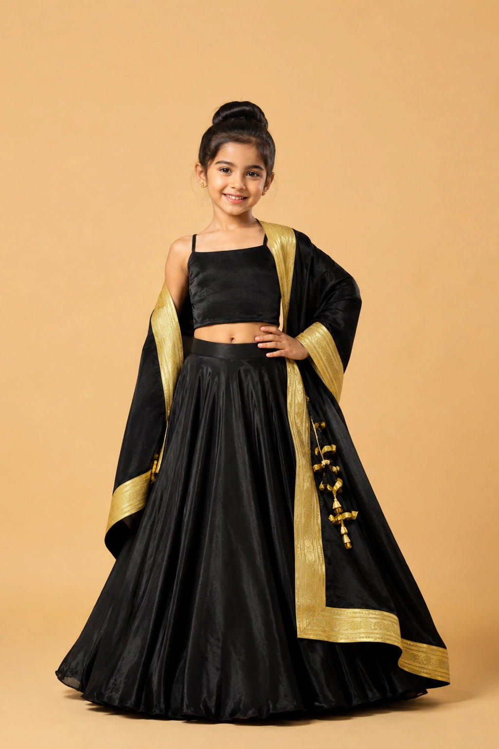 A black modal satin lehenga paired with a sleeveless blouse and a dupatta adorned with golden lace and latkan details.