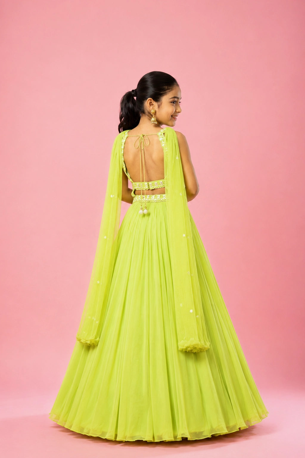 A lime green georgette lehenga featuring intricate hand embroidery on the blouse and belt, paired with a soft net choker-style dupatta.