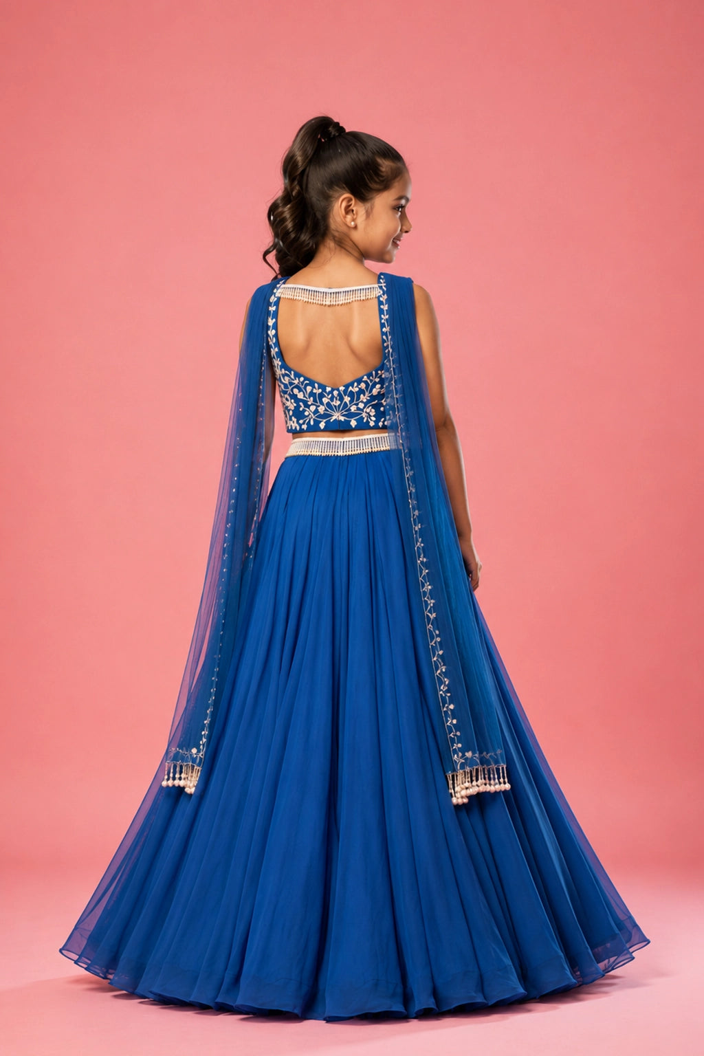 Cobalt blue lehenga crafted in georgette, pearl embroidery on the blouse and belt. Paired with a choker-style soft net dupatta