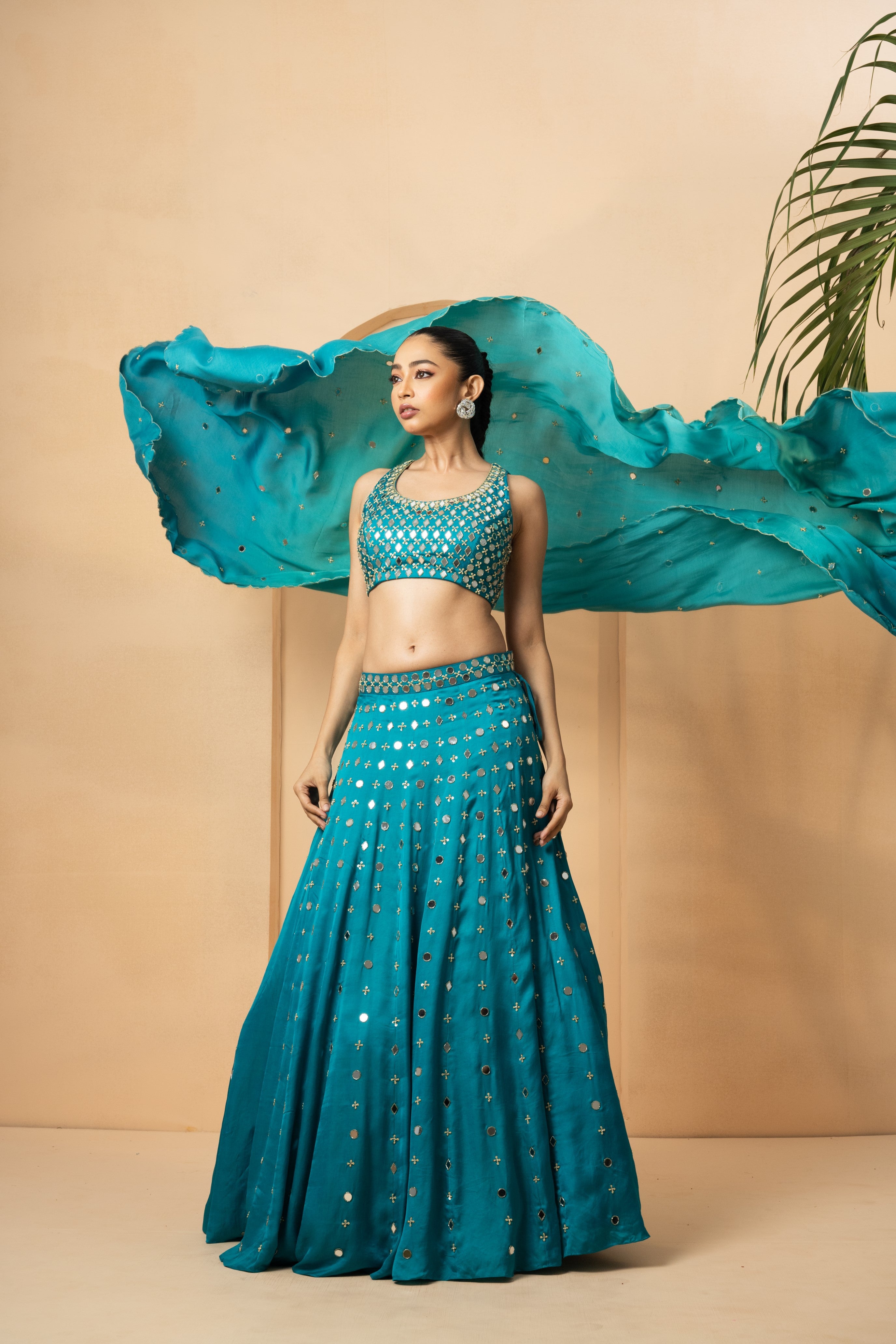 Turquoise mirror lehenga set with pearl beadwork and matching dupatta.