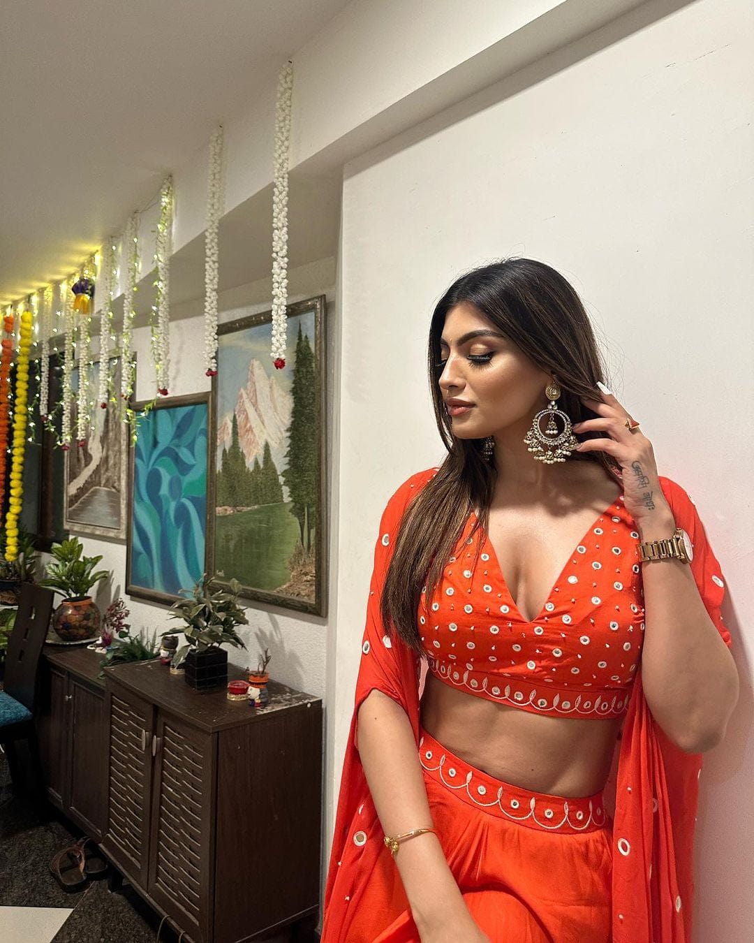 Tangerine orange dhoti set with a mirror-work blouse, dhoti, and georgette cape, worn by Akansha Puri.