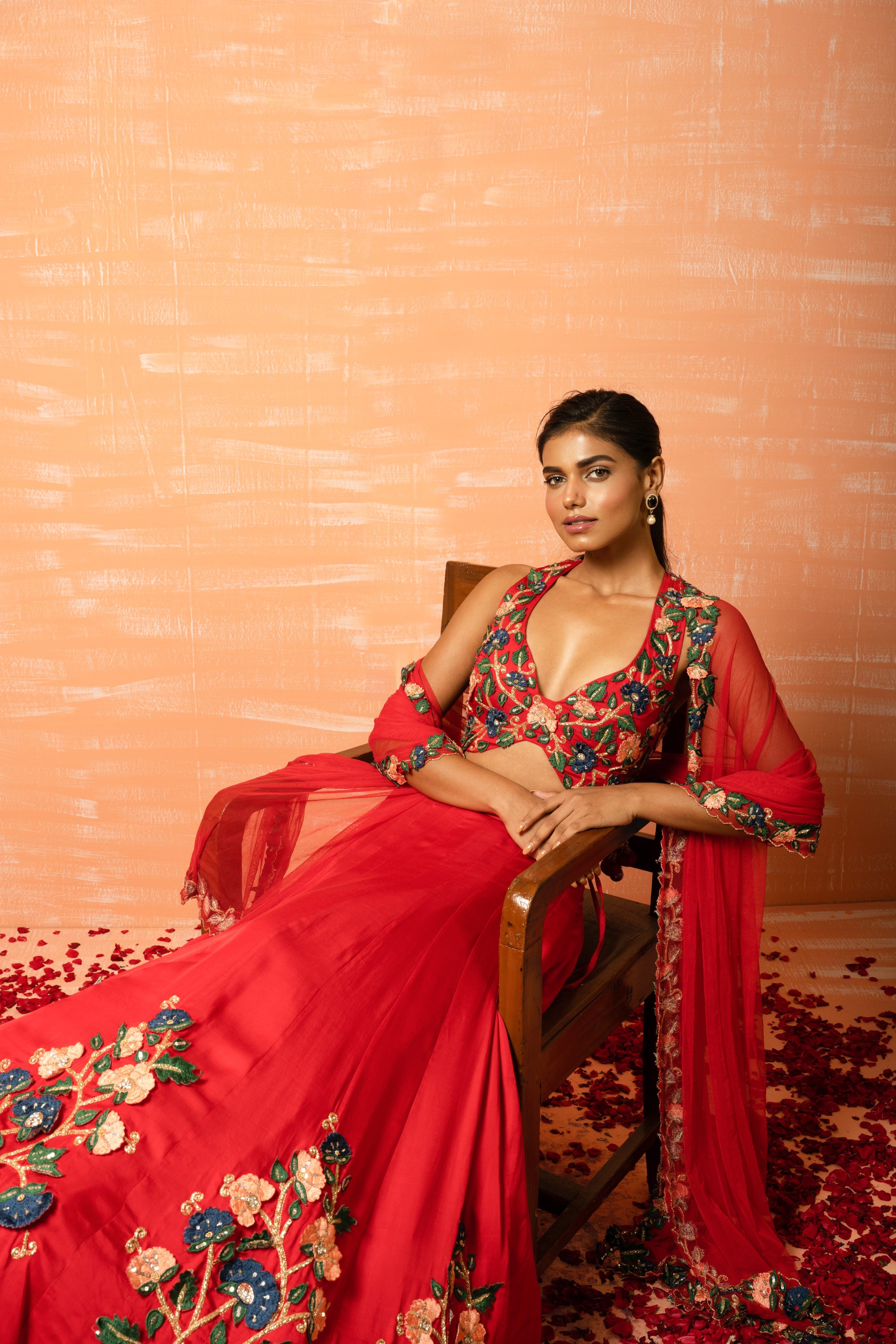 Red modal silk lehenga with 3D applique embroidery and a soft net dupatta.
