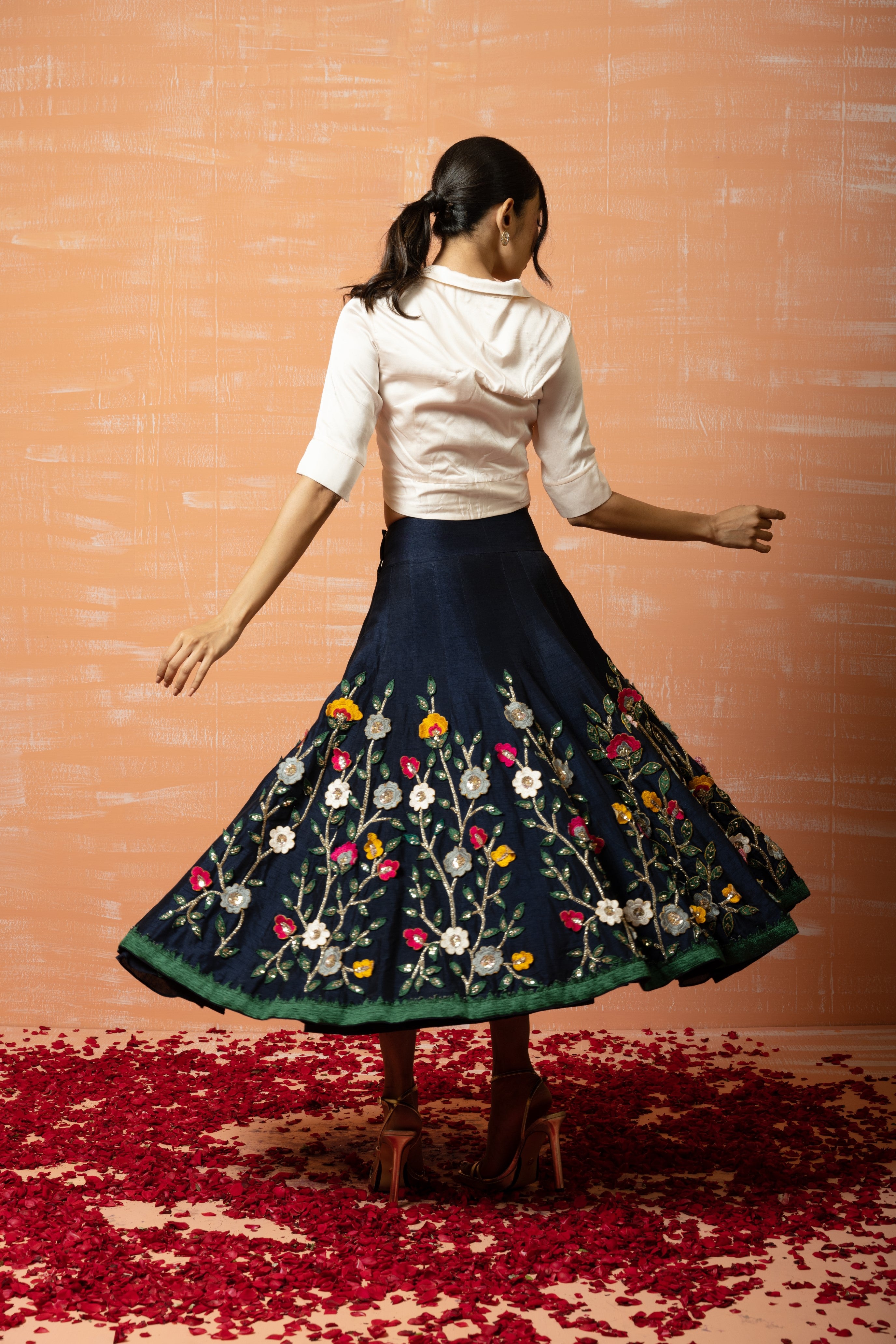 White shirt and blue 3D half lehenga set with intricate applique embroidery.