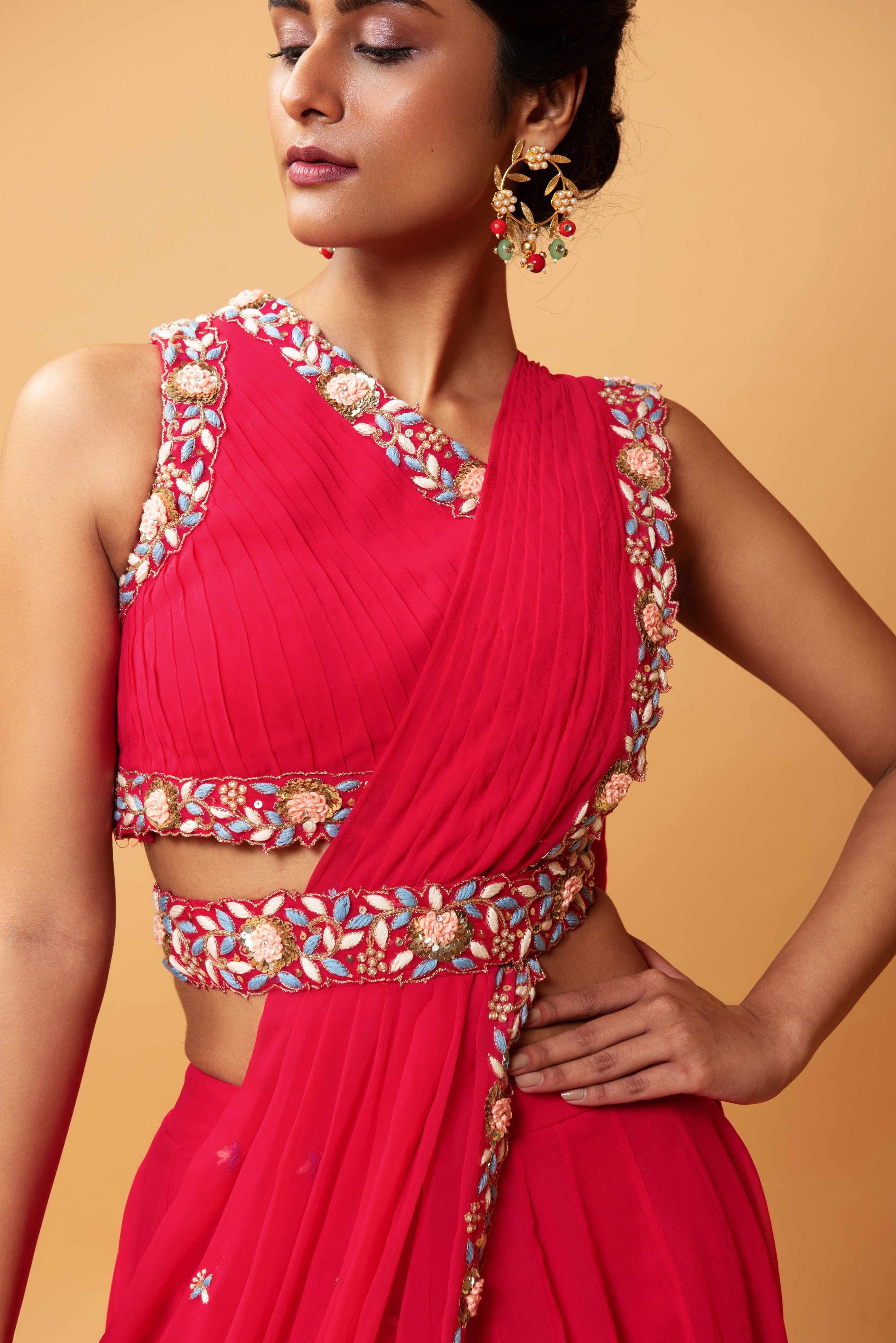 Fuschia pink draped lehenga with hand-embroidered waist belt.